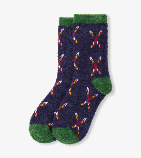 Navy fuzzy socks with green accents and a crossed skis pattern in red, white, and yellow. One size.