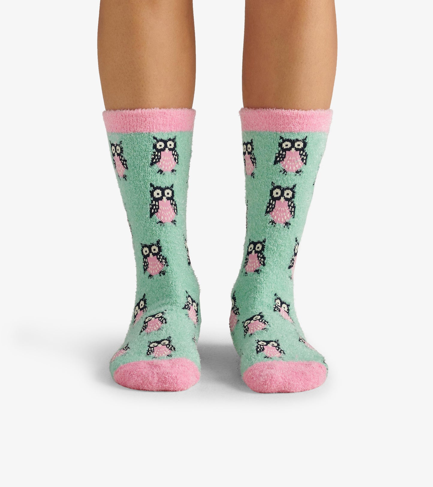 Fuzzy mint green socks featuring a playful owl pattern, with pink cuffs and soles, designed for cozy wear.