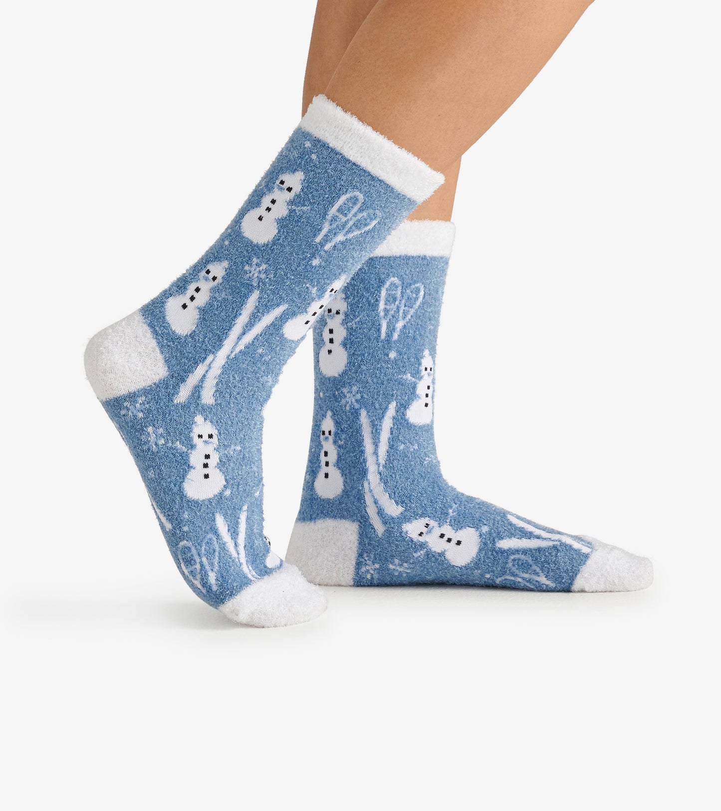 Fuzzy blue socks featuring white snowmen and snowflakes, with a soft white cuff, perfect for cozy winter wear.