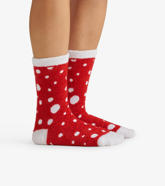 Red fuzzy socks with white polka dots and a white cuff, designed for warmth and comfort.