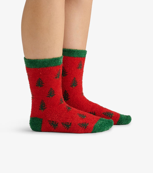 Red fuzzy socks with green trim, featuring a pattern of black trees, designed for adults.
