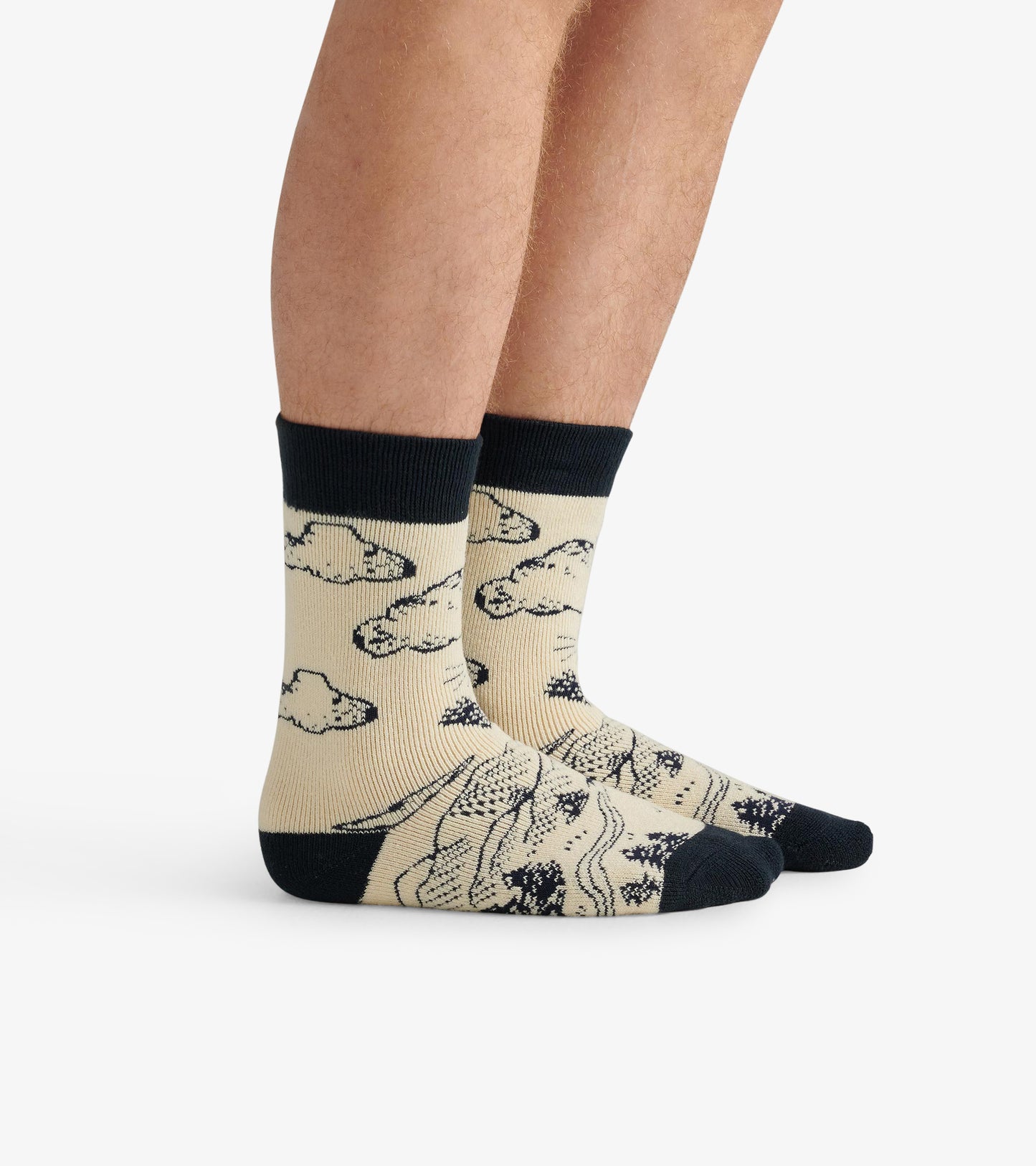 Beige cozy socks featuring a bear and cloud pattern, with a dark ribbed cuff and toe. One size fits most.