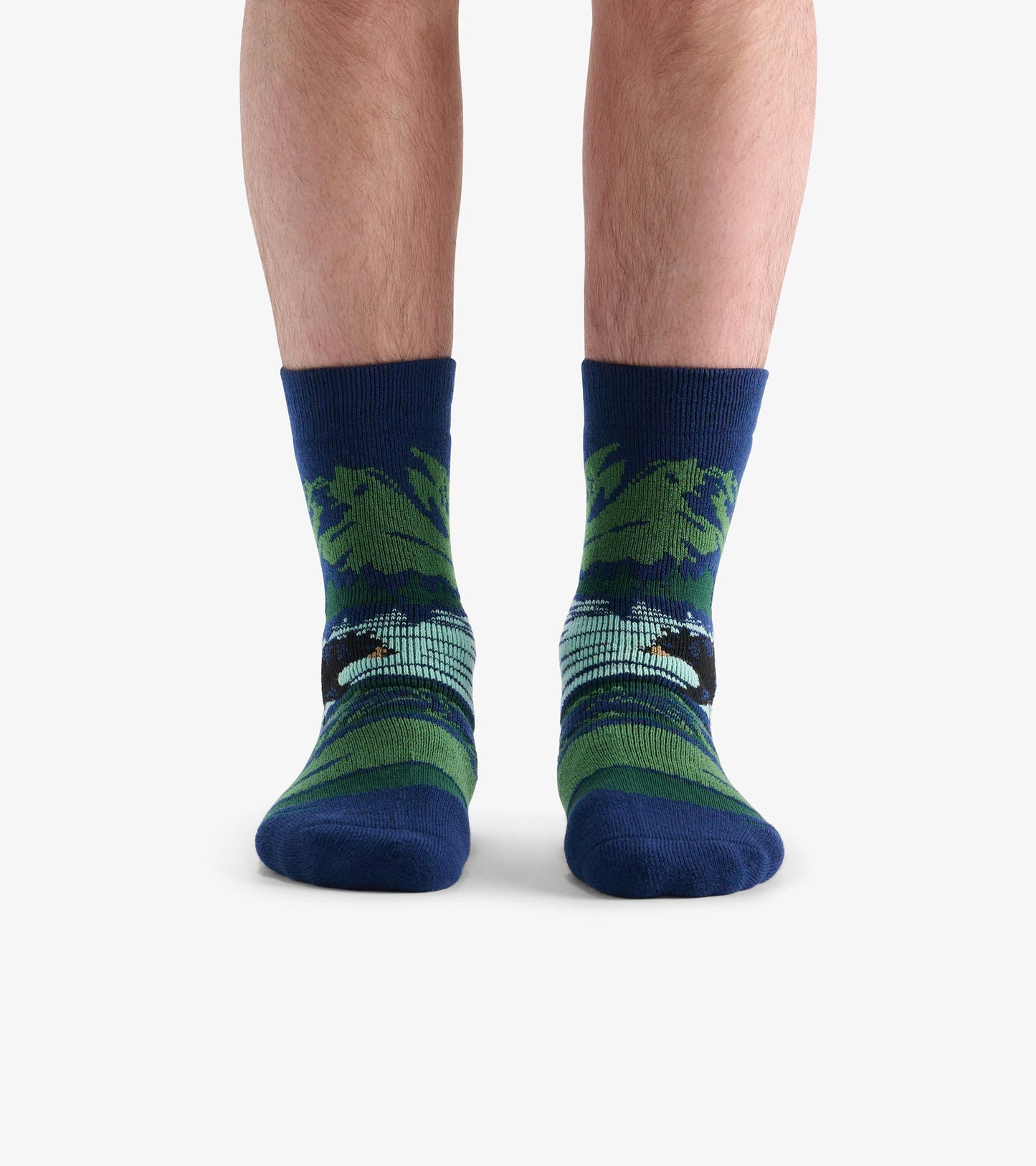 Cozy socks featuring a bear design in green and blue, with a ribbed cuff and comfortable fit.