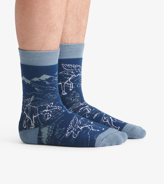 Cozy blue socks featuring a moose and mountain pattern, designed for warmth and comfort. One size fits most.