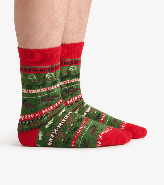 Green and red cozy socks featuring a festive moose pattern and "MERRY X-MOOSE" text, suitable for winter wear.