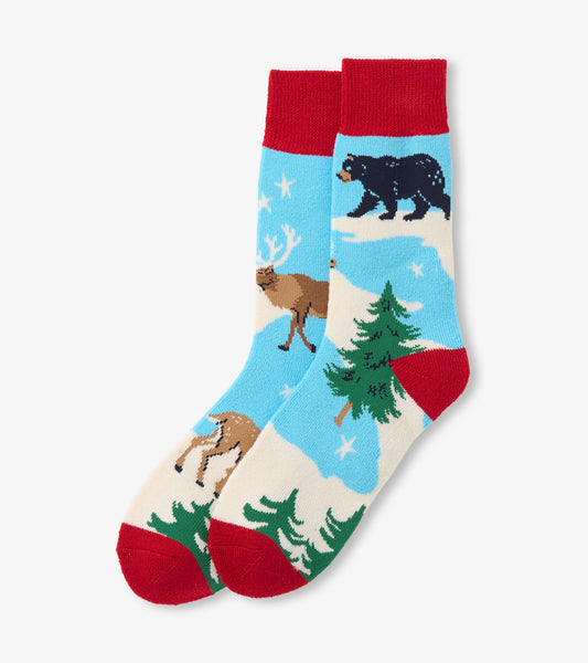 Cozy socks featuring a winter scene with a bear, deer, and trees on a blue background, with red cuffs and toe.