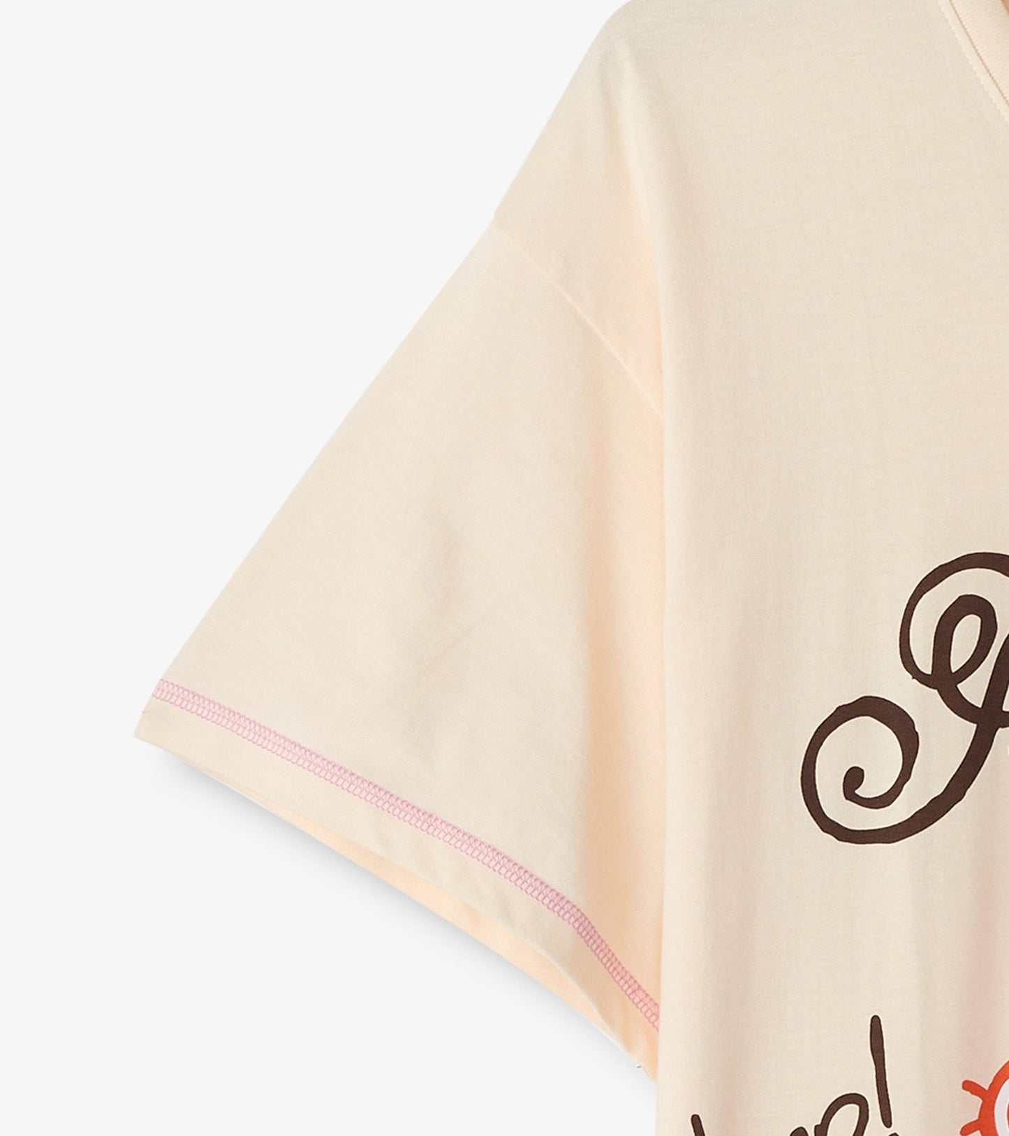 Peach-colored women's sleepshirt with short sleeves and playful text design.