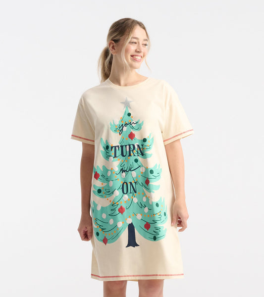 Cream-colored sleepshirt featuring a colorful Christmas tree graphic with text, short sleeves, and a relaxed fit.