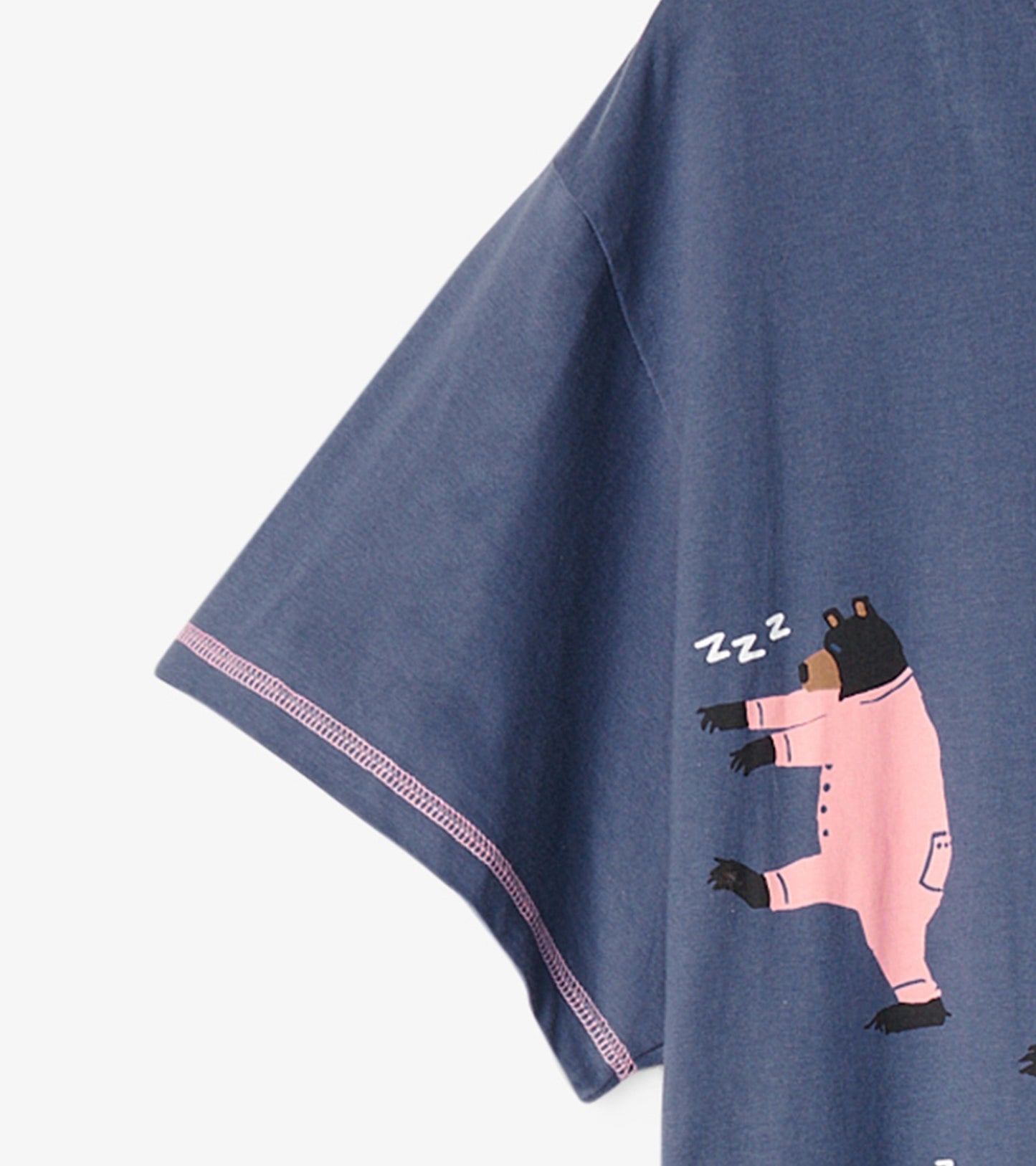 Navy blue sleepshirt with short sleeves featuring a playful bear graphic in pink pajamas.