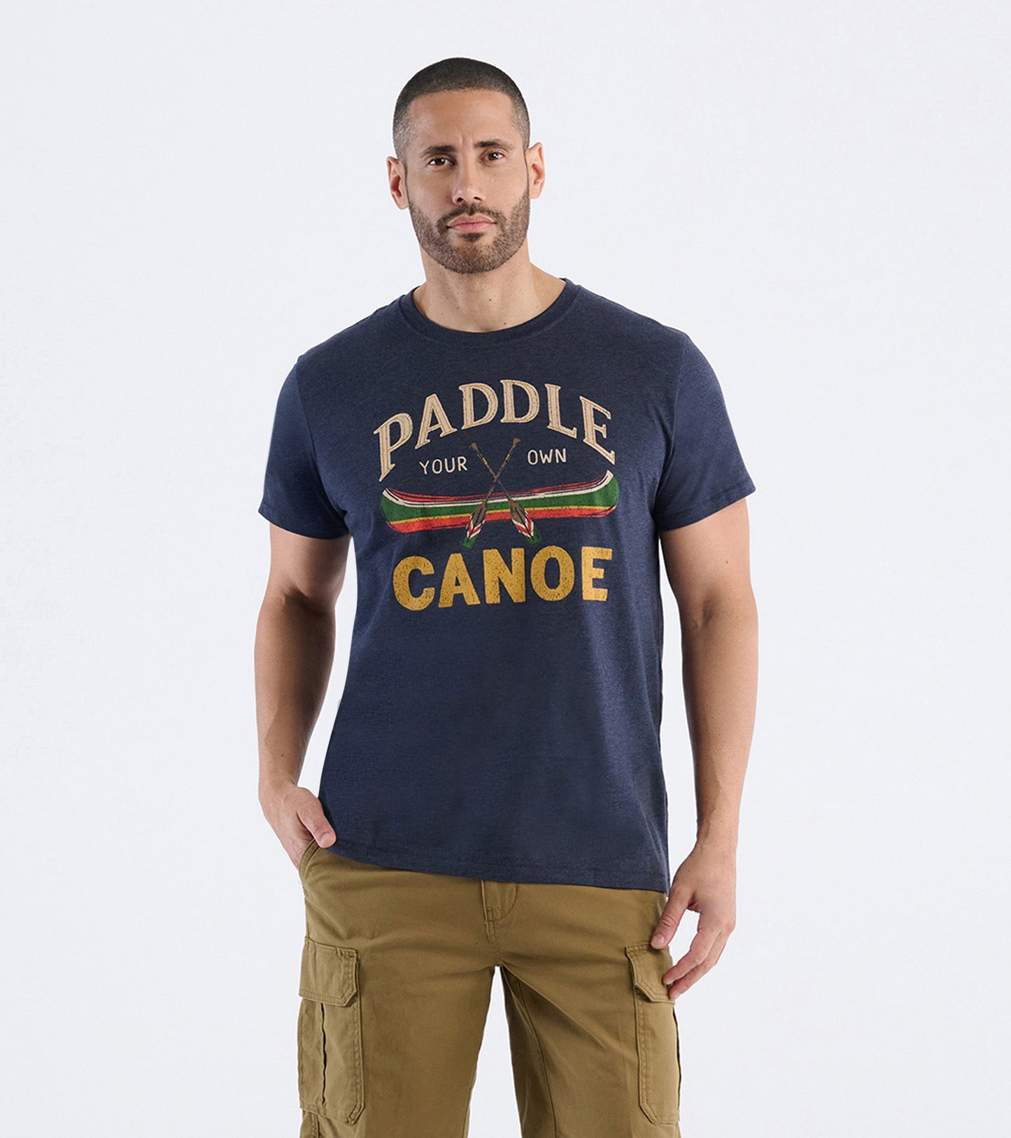 Navy blue cotton t-shirt featuring a canoe graphic and text design, worn by a model with khaki cargo shorts.