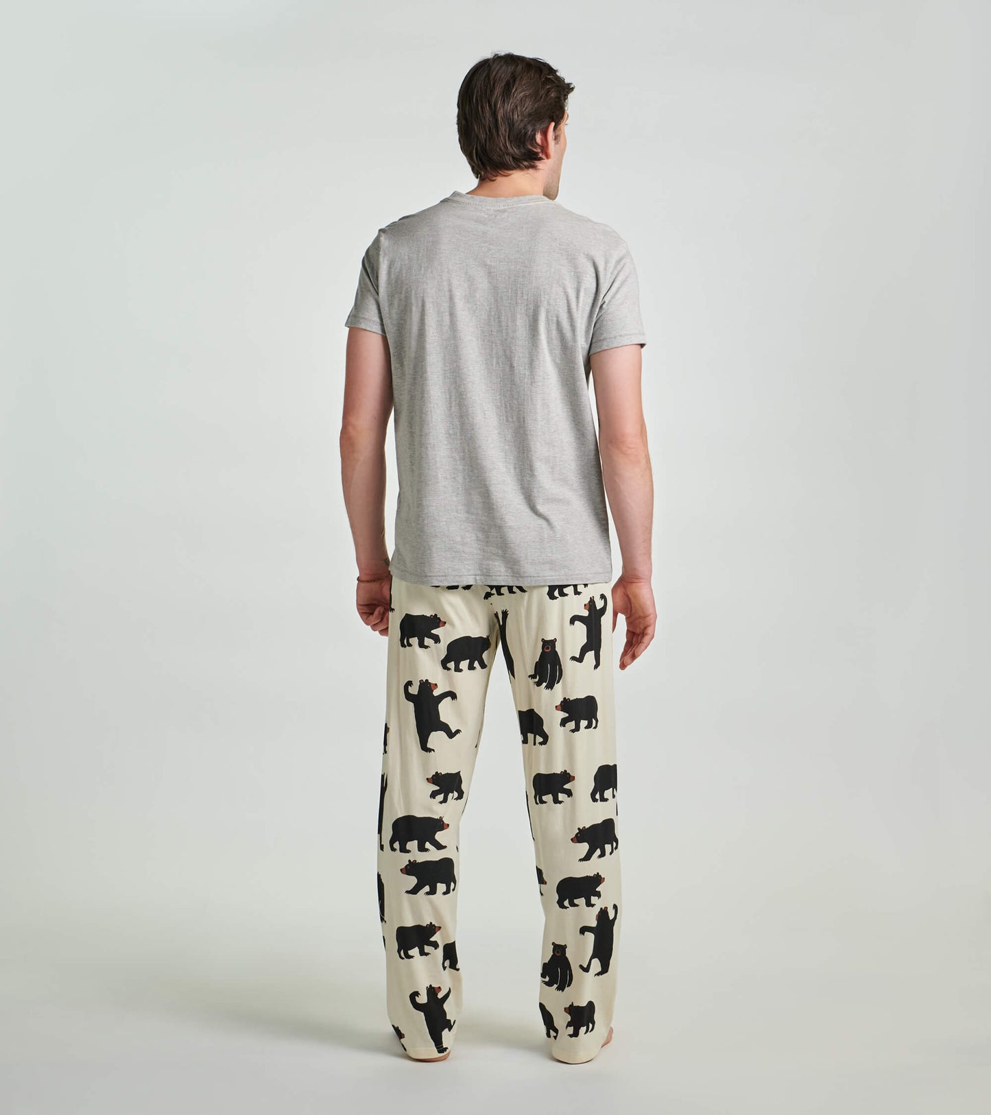 Grey men's tee with a black bear design, worn with patterned pajama pants featuring multiple bear silhouettes.