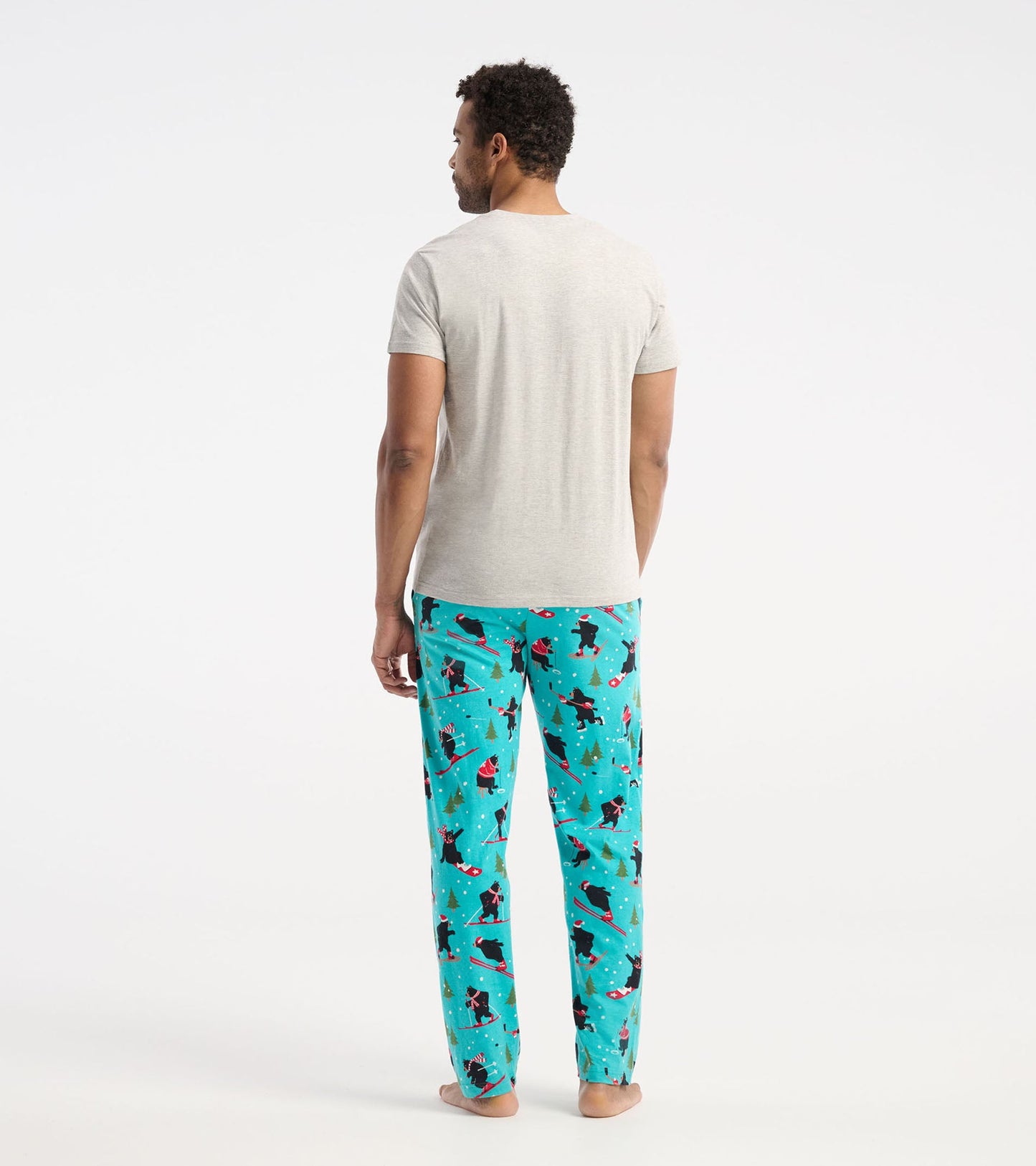 Gray short-sleeve t-shirt paired with colorful patterned pajama pants featuring skiing bears and trees.