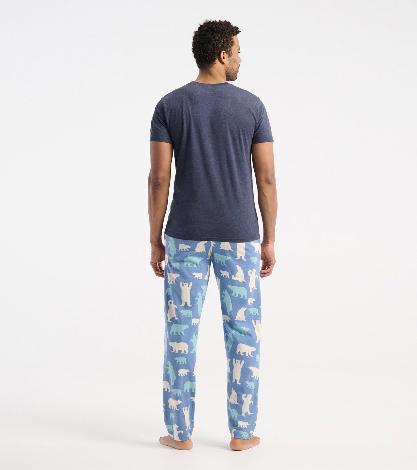 Navy blue short-sleeve t-shirt worn with patterned pajama pants featuring polar bears and other animals.