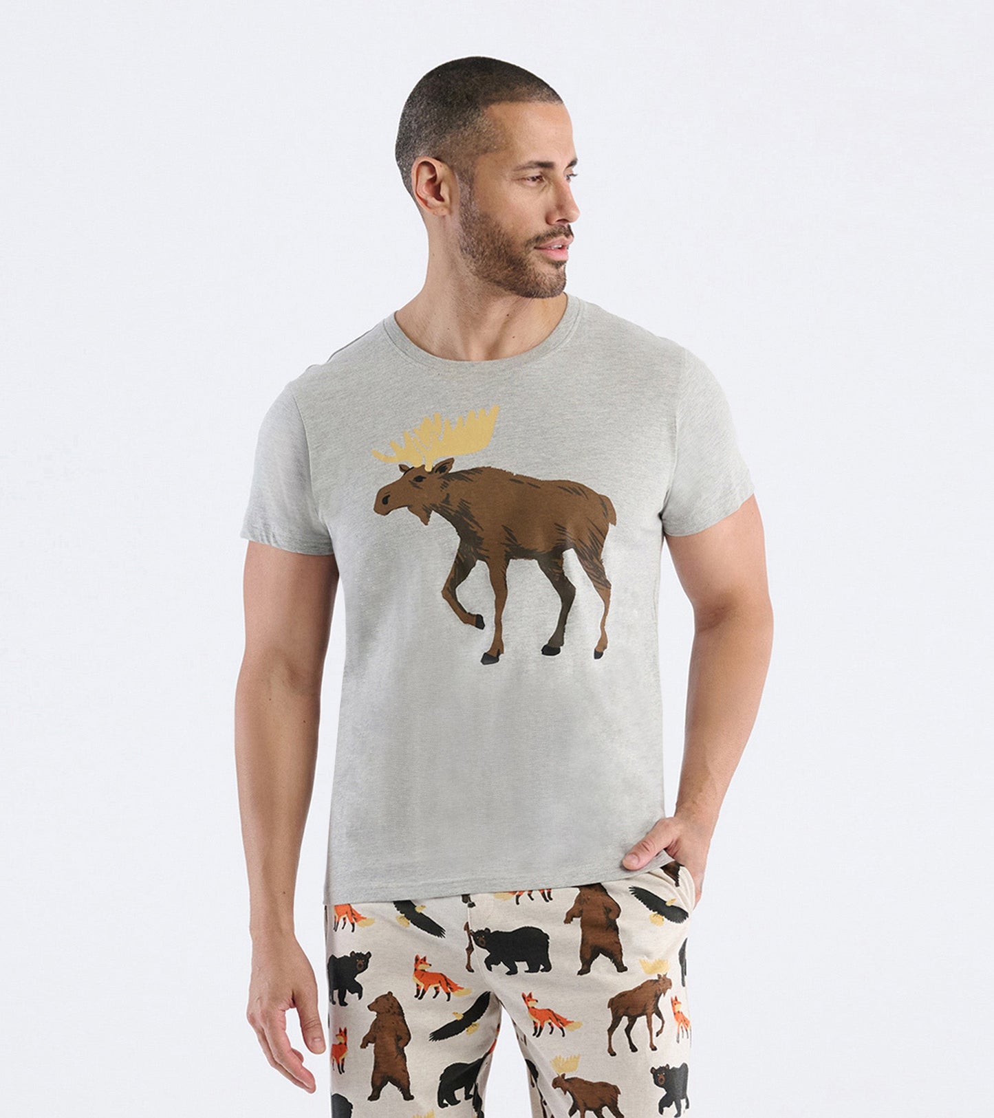 Light gray men's tee featuring a moose graphic, paired with patterned pajama pants.