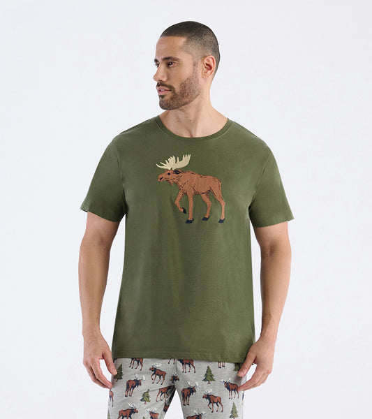 Olive green short-sleeve t-shirt featuring a moose graphic on the front, worn with patterned pajama pants.