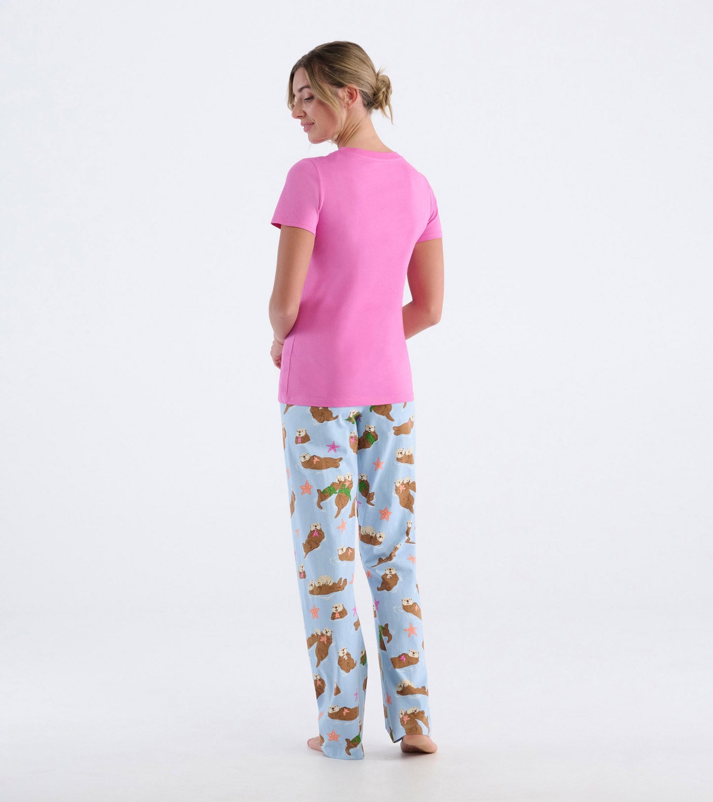 Pink short-sleeve pajama t-shirt paired with light blue pants featuring a playful otter print.