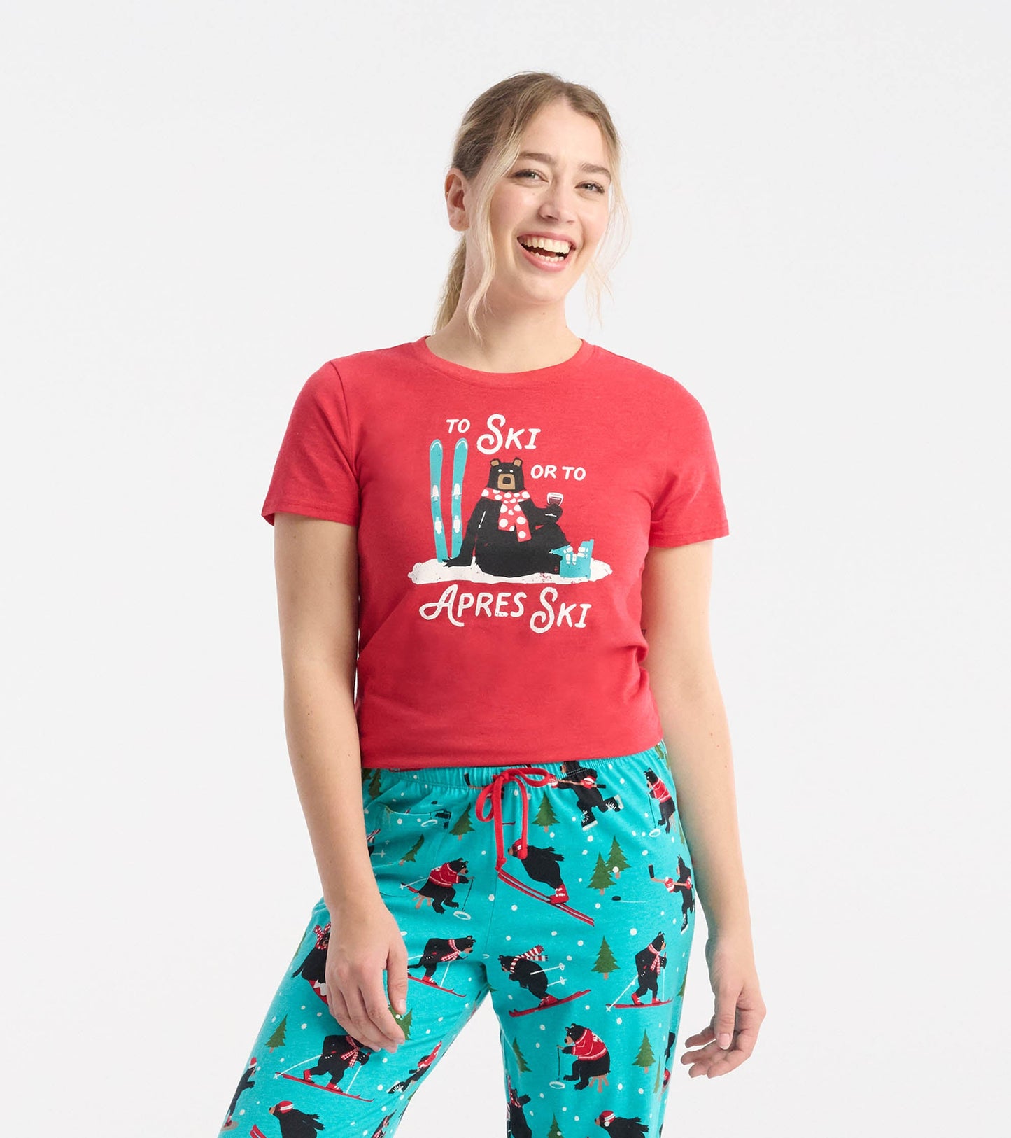 Red pajama tee featuring a bear graphic with skis, paired with turquoise pants adorned with skiing bears and trees.