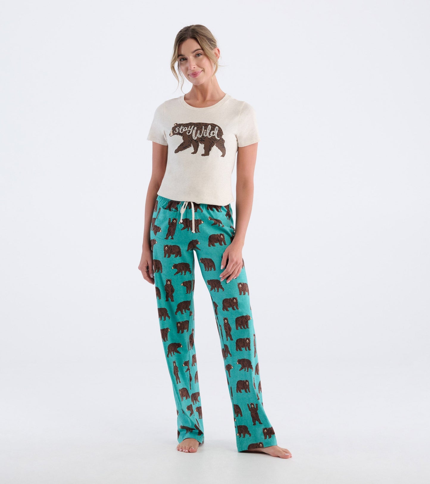 Cream short-sleeve pajama t-shirt with "stay wild" graphic, paired with teal pants featuring brown bear prints.
