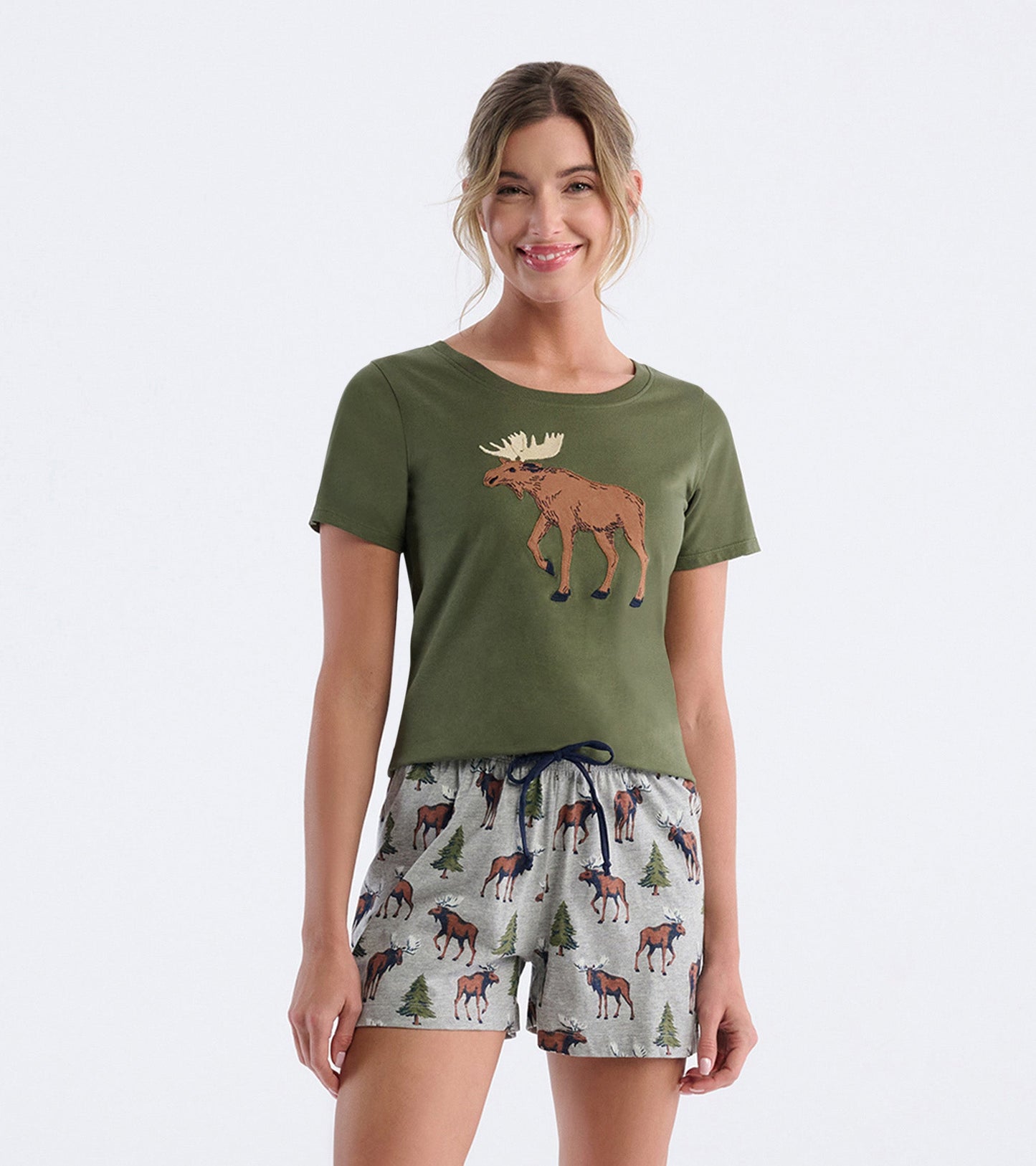 Olive green pajama t-shirt featuring a moose graphic, paired with gray shorts adorned with moose and trees.