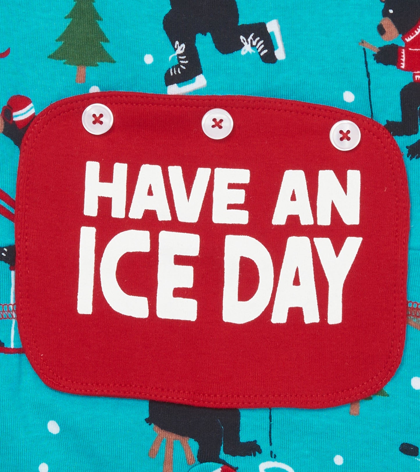 Turquoise union suit featuring playful winter sports graphics and a red patch with the text "HAVE AN ICE DAY.