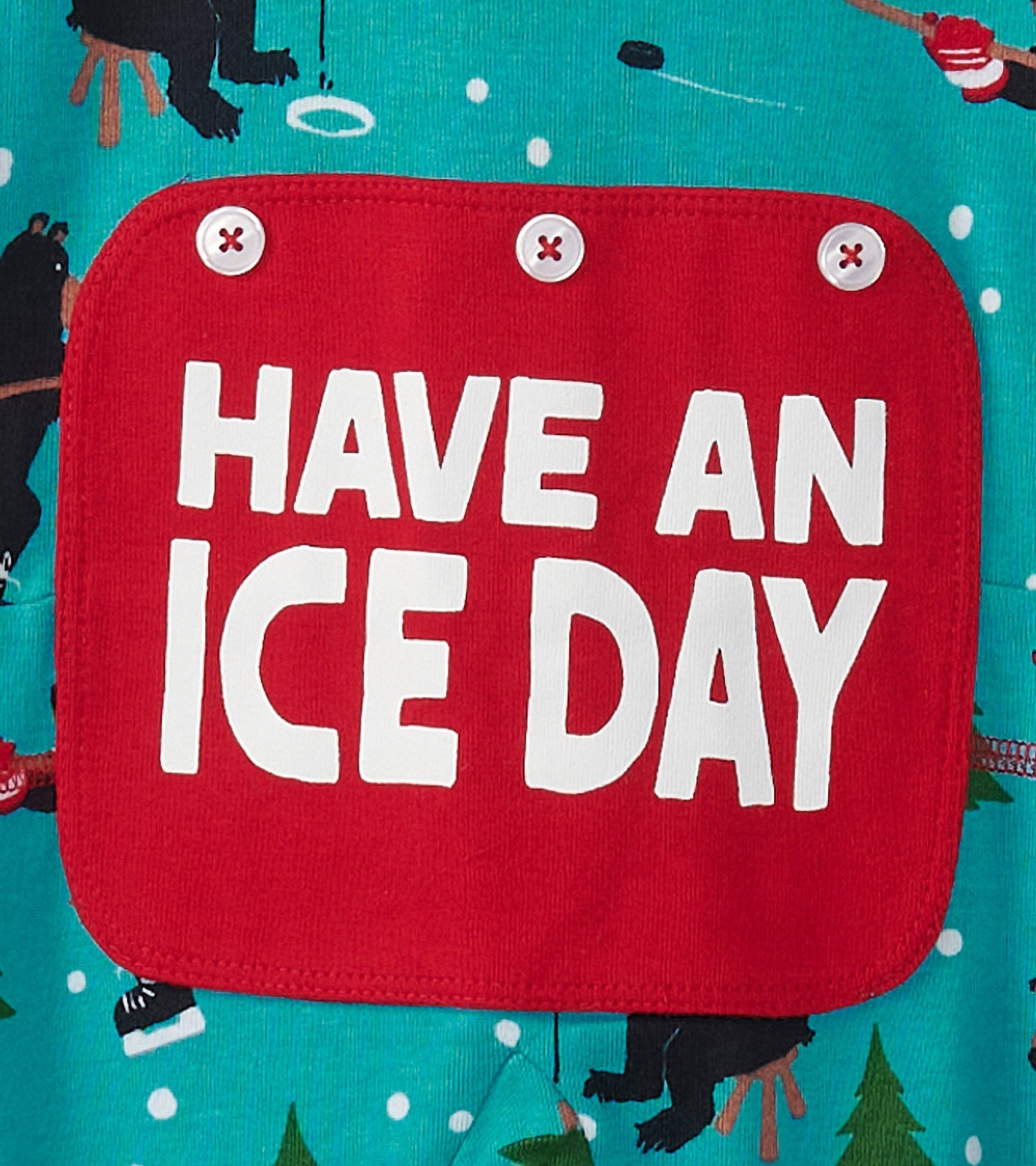 Turquoise onesie featuring a playful bear pattern and a red patch with the text "HAVE AN ICE DAY.