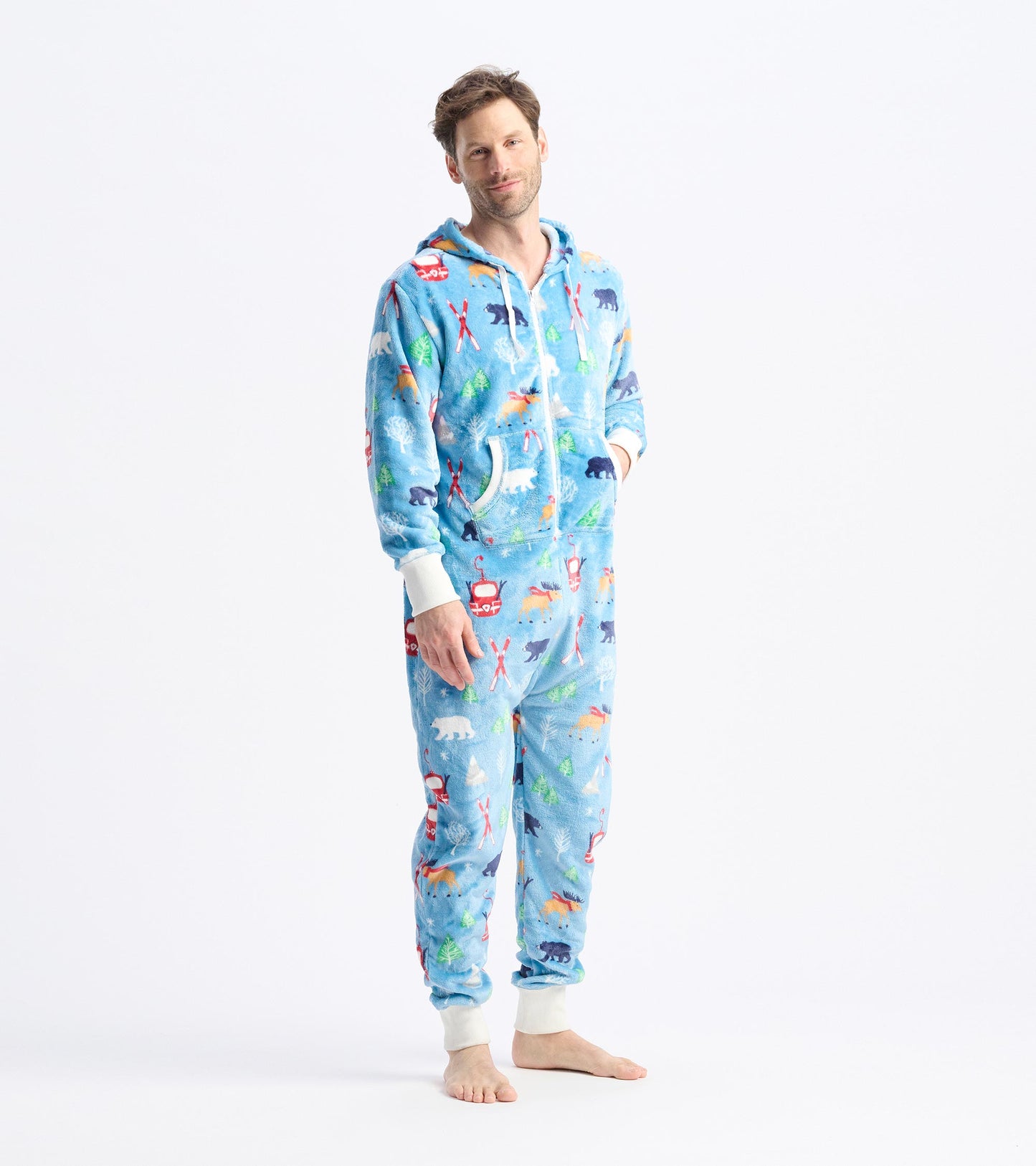 Light blue fleece jumpsuit with colorful winter-themed patterns, featuring a hood and front pockets.