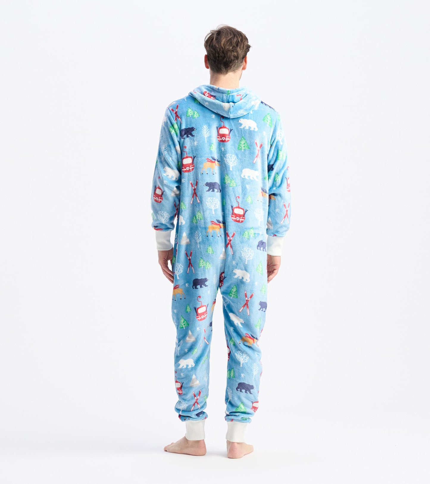 Hooded fleece jumpsuit in light blue with colorful winter-themed patterns, featuring bears, trees, and ski motifs.
