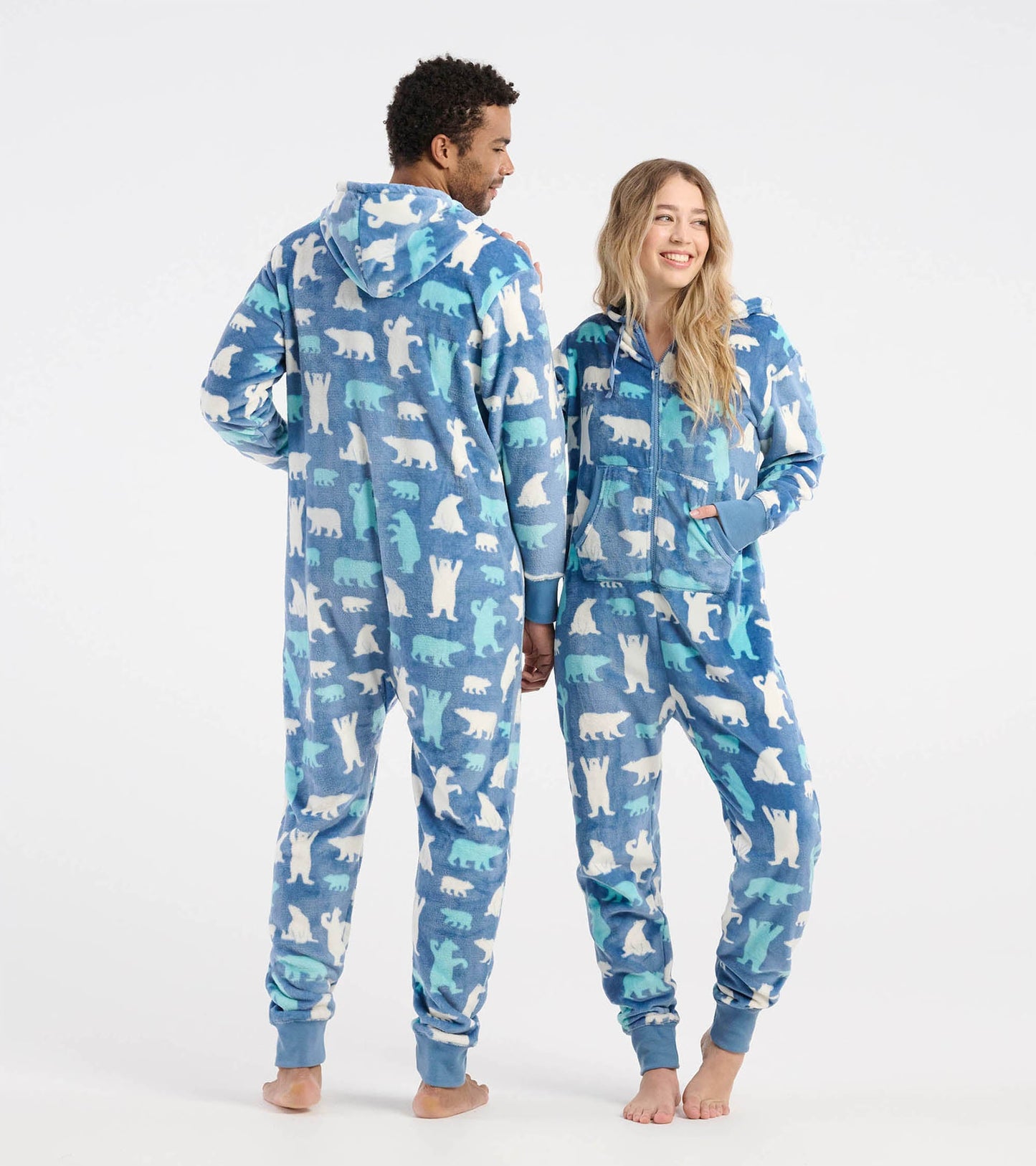 Blue fleece hooded jumpsuit featuring polar bear patterns, designed for adults, shown on two models from the back and side.