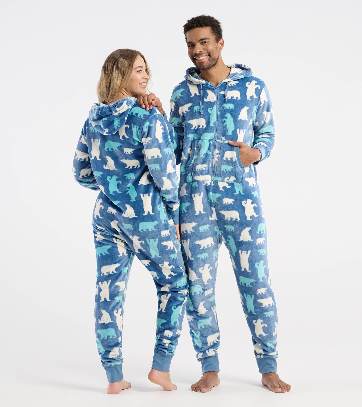 Blue fleece hooded jumpsuit featuring polar bear patterns, designed for adults, shown on two models.