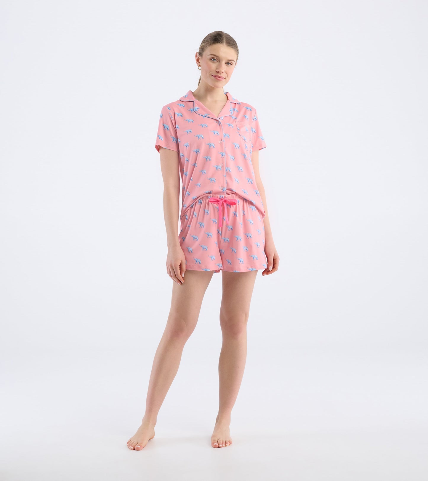 Pink short pajama set featuring a button-up top and elastic waistband shorts with blue elephant print.