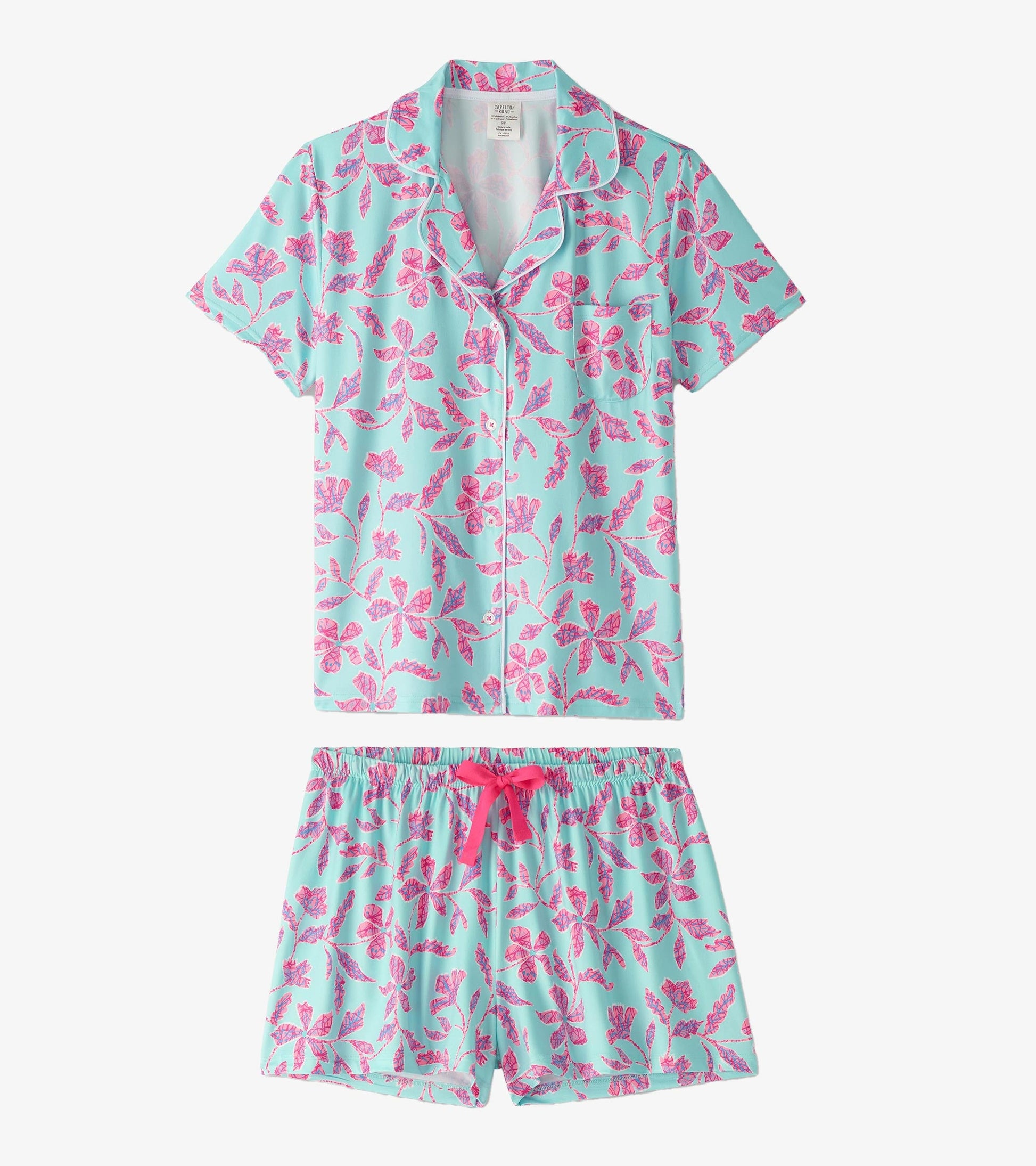 Turquoise short pajama set featuring a floral batik pattern in pink, with a button-up top and elastic waistband shorts.