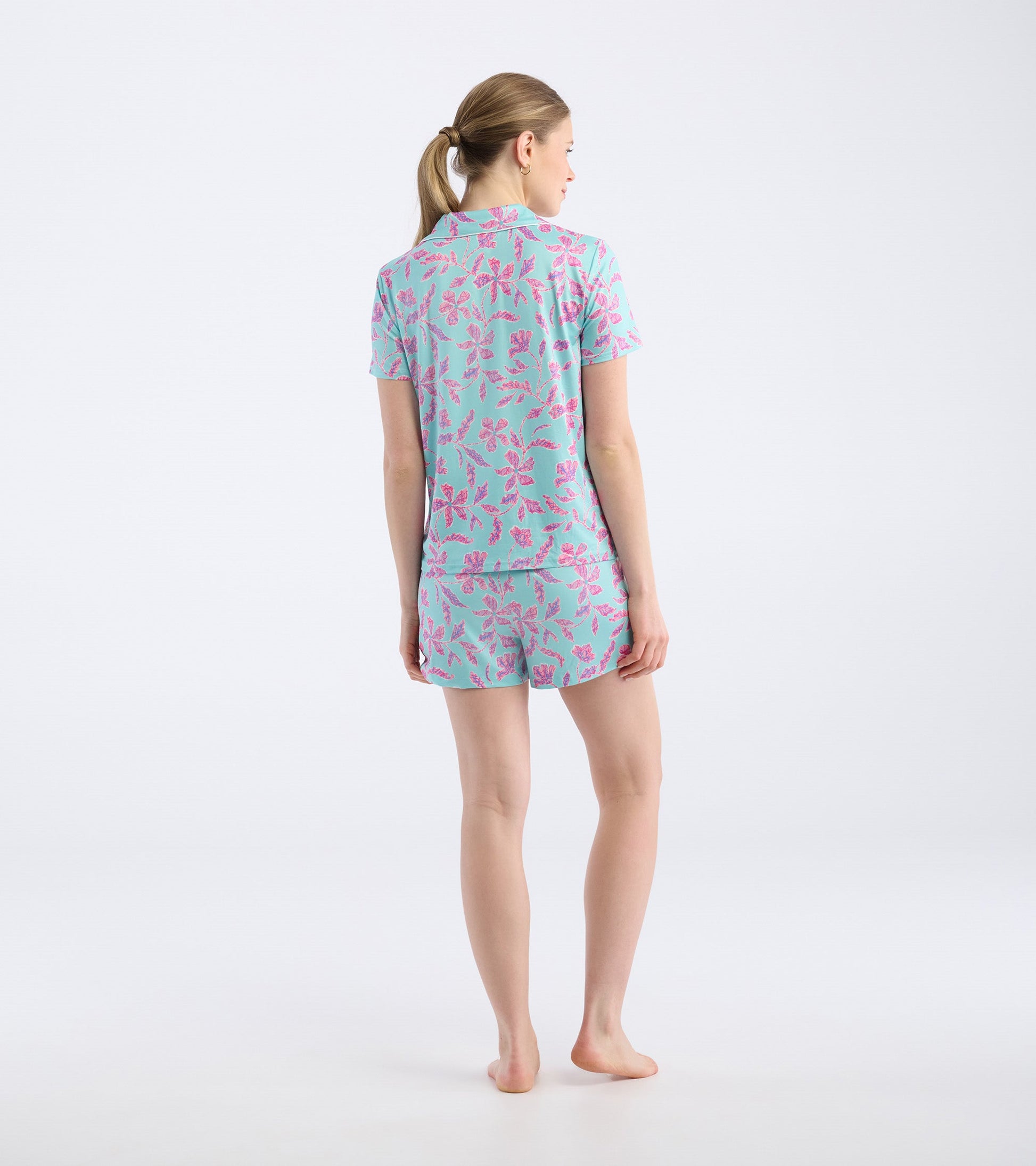 Turquoise short pajama set featuring a pink batik floral pattern, shown from the back.