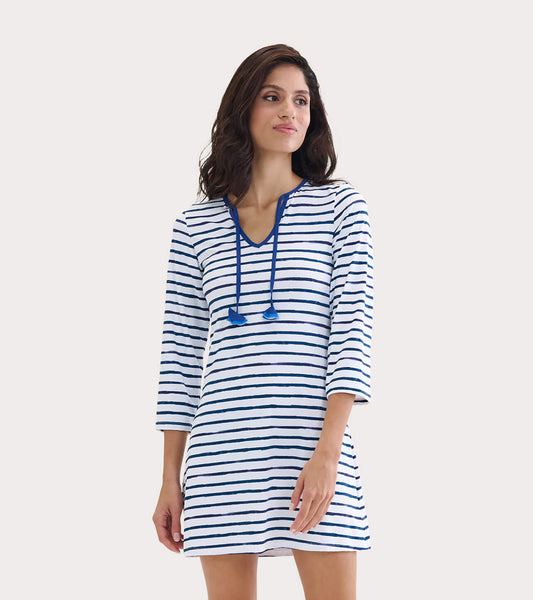 White dress with blue watercolor stripes, V-neck, and drawstring detail, suitable for beachwear.