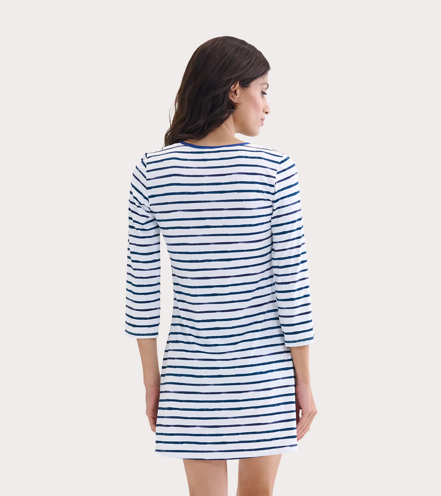 Back view of a women's dress featuring a watercolor stripe pattern in navy and white, with three-quarter sleeves.