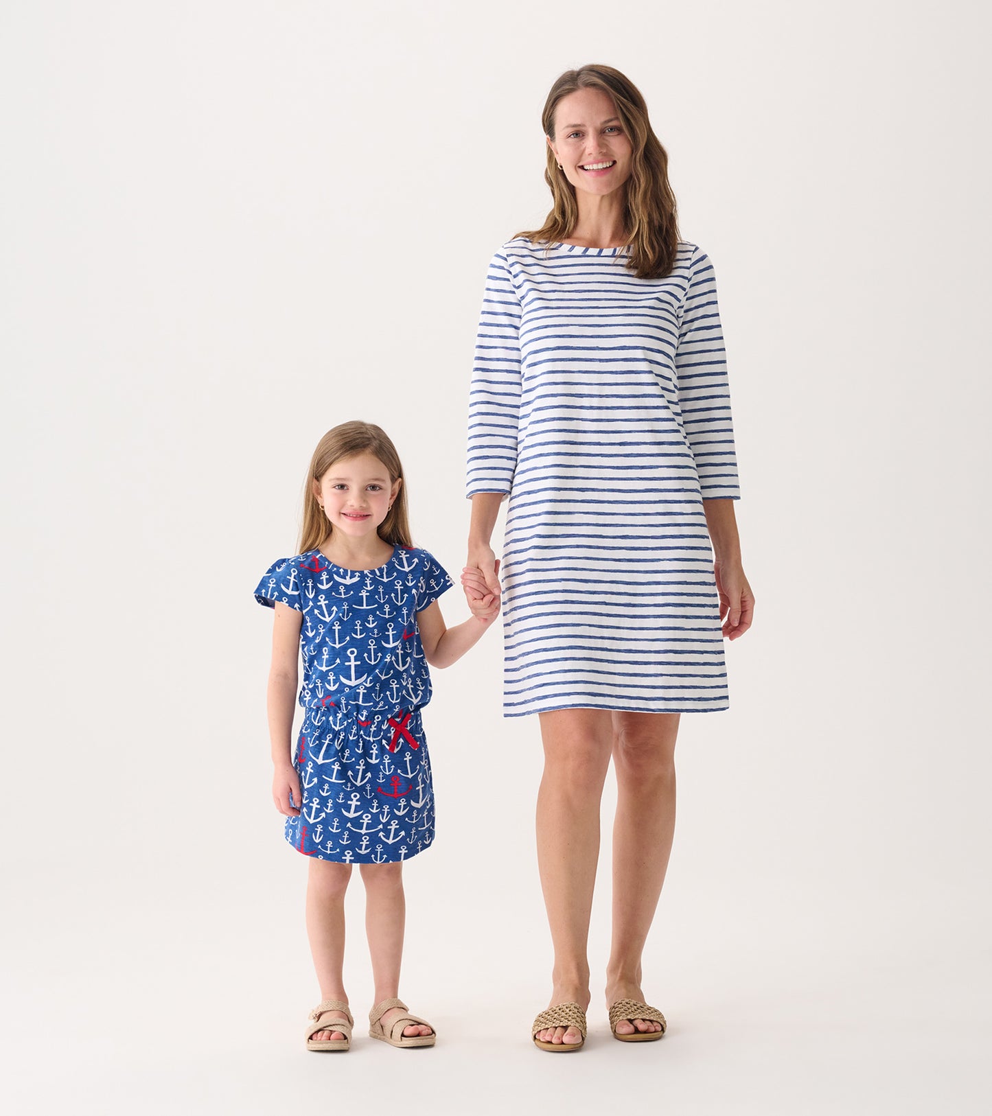 Women's 3/4 sleeve summer dress featuring a white and blue watercolor stripe pattern, paired with a girl in an anchor print…