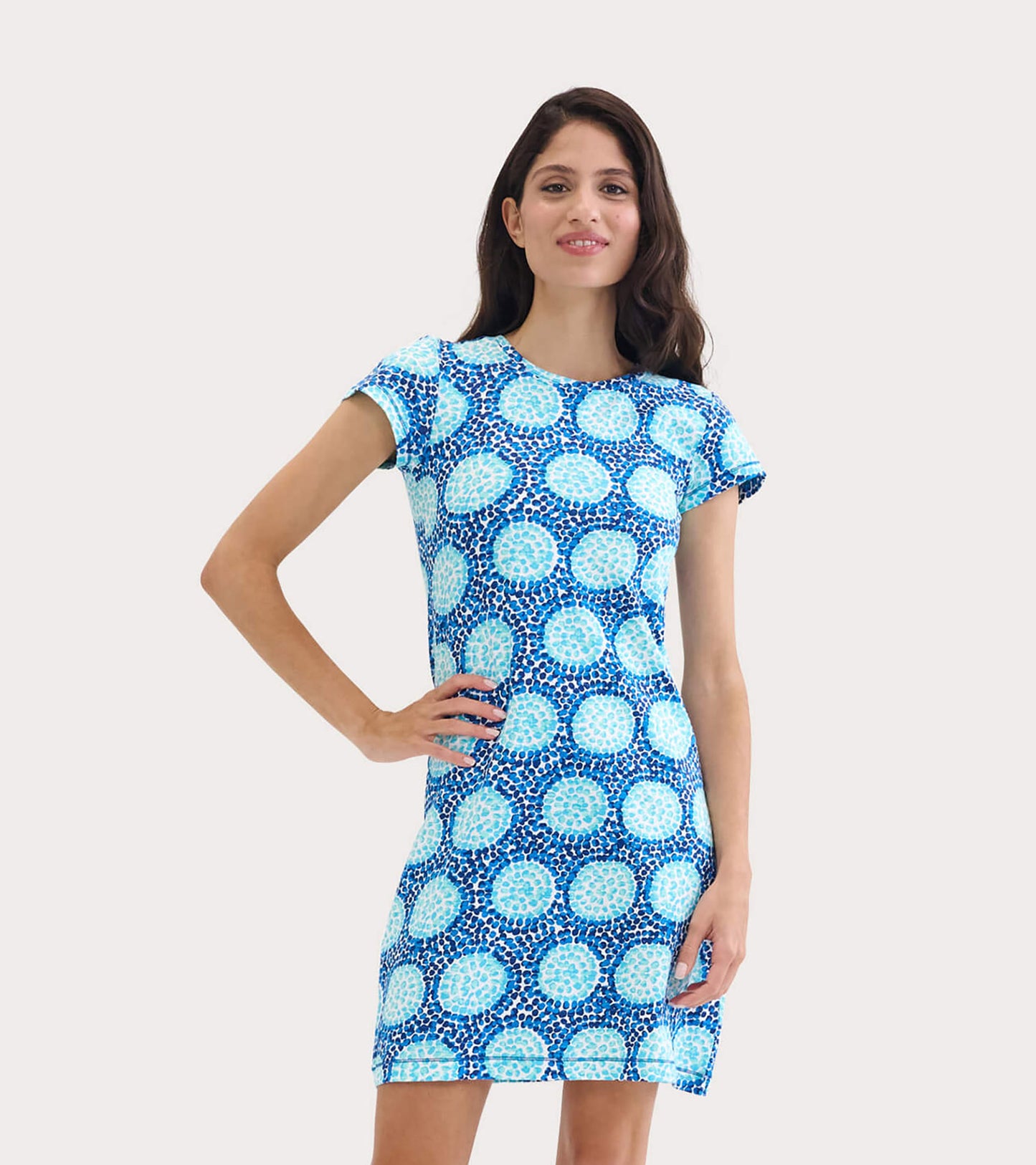 Short-sleeve crew neck dress in blue with a circular pattern, fitted silhouette, suitable for casual wear.