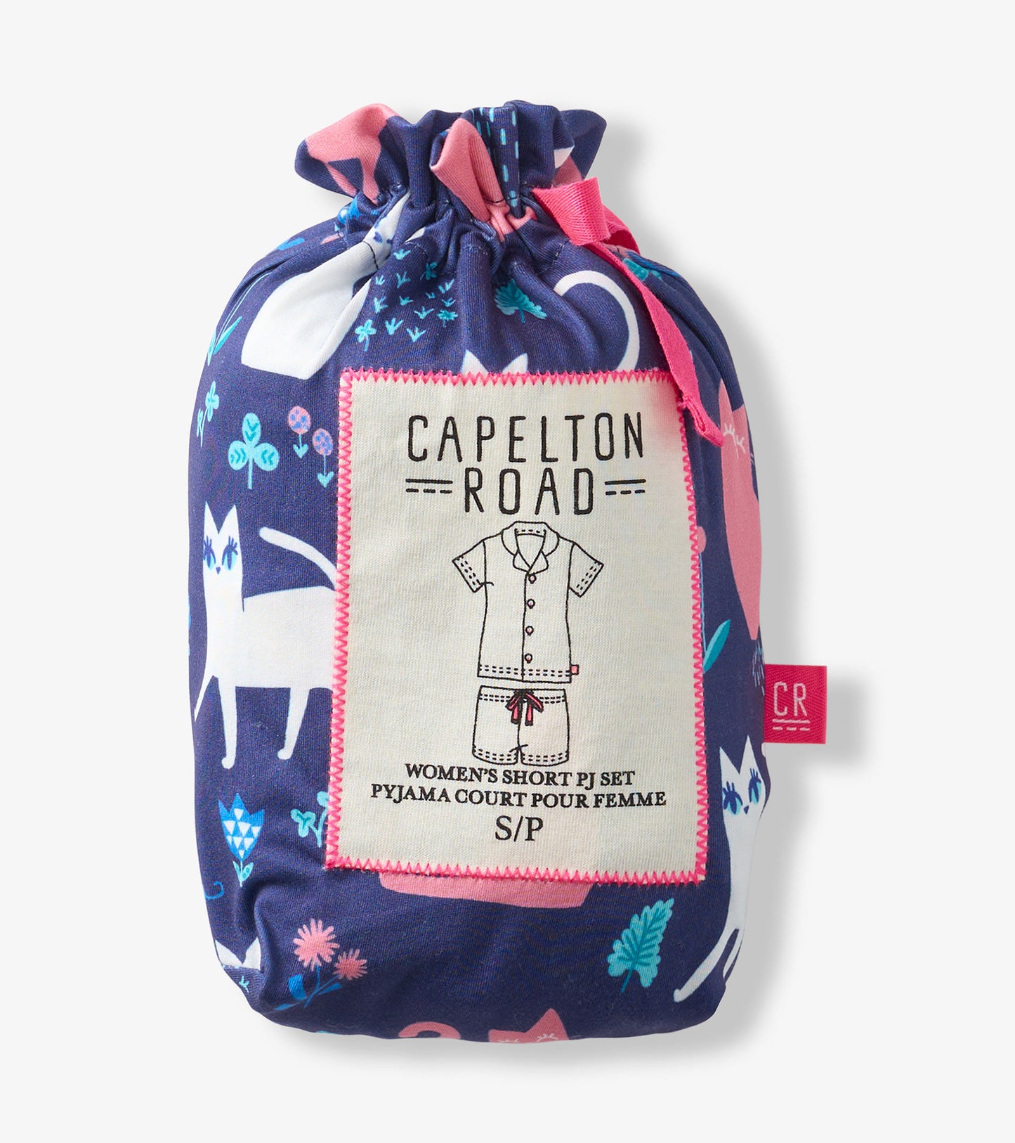 Folded navy pajama set with pink and teal cat print, tied in a drawstring pouch with label.