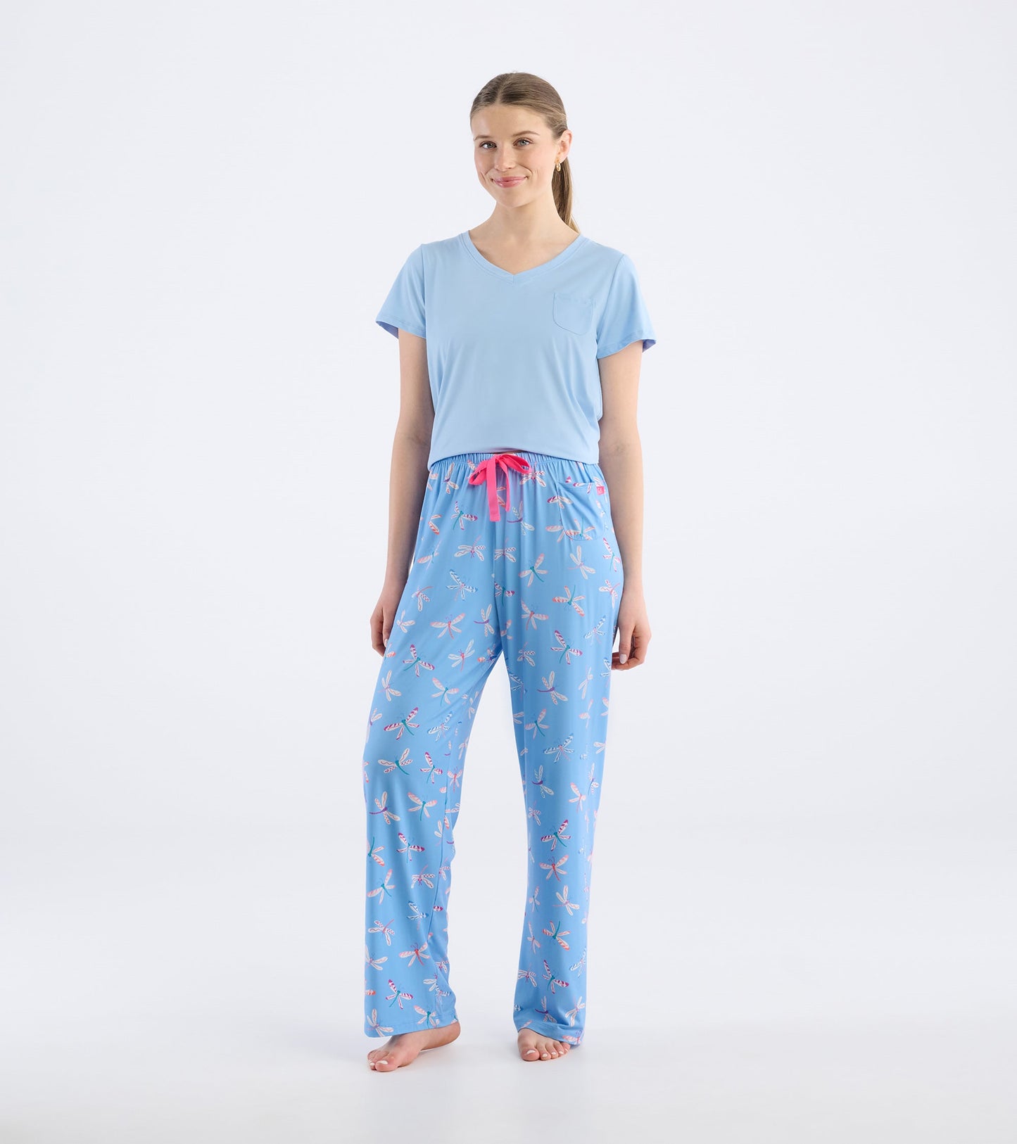 Light blue pajama pants with a dragonfly pattern and pink drawstring, styled for comfort and relaxation.