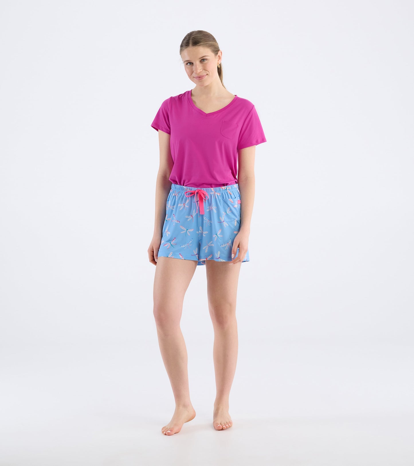 Light blue pajama shorts with dragonfly pattern and pink drawstring, paired with a pink V-neck top.