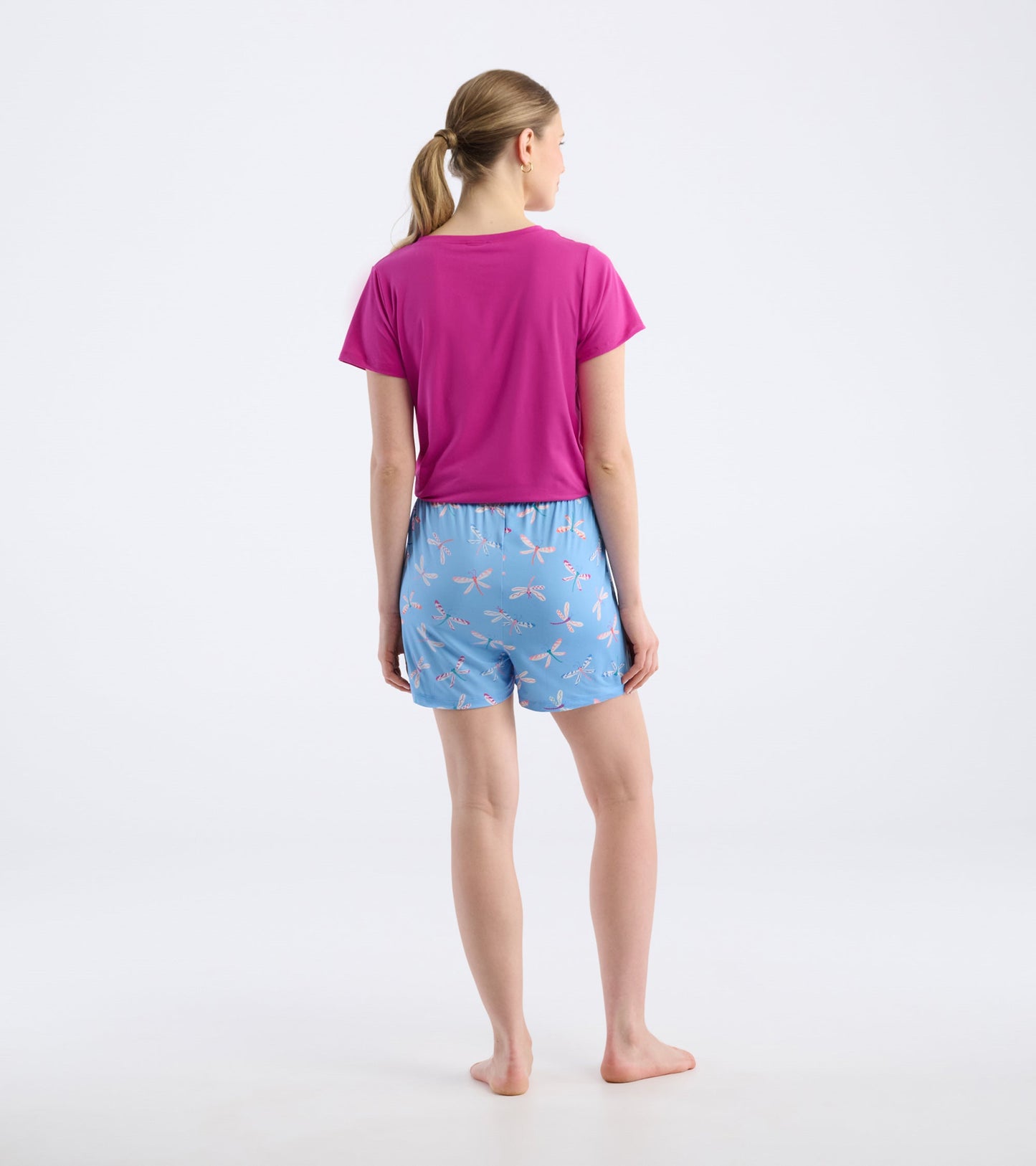 Back view of women's blue pajama shorts featuring a dragonfly pattern, made from soft polyknit material.