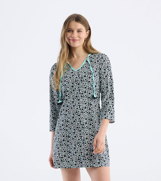 Black and white floral print mini dress with a V-neck and turquoise accents, perfect for seaside outings.