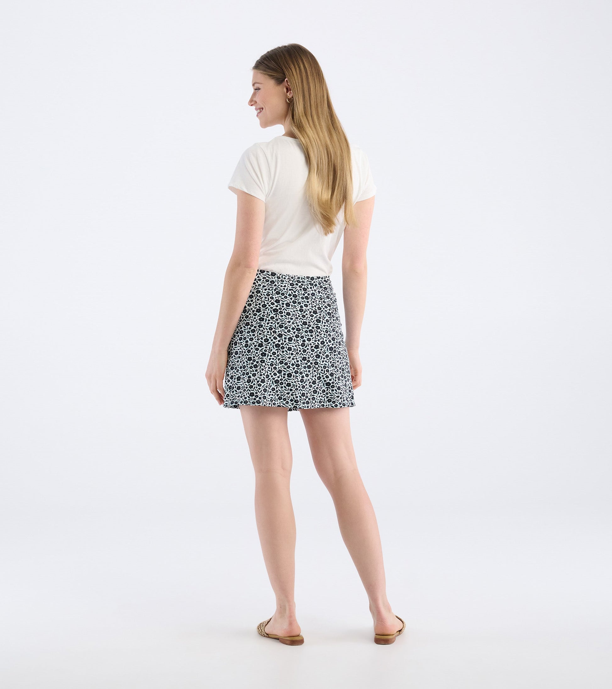 Black and white floral skort with a flared shape, worn with a light top, showing the back view.