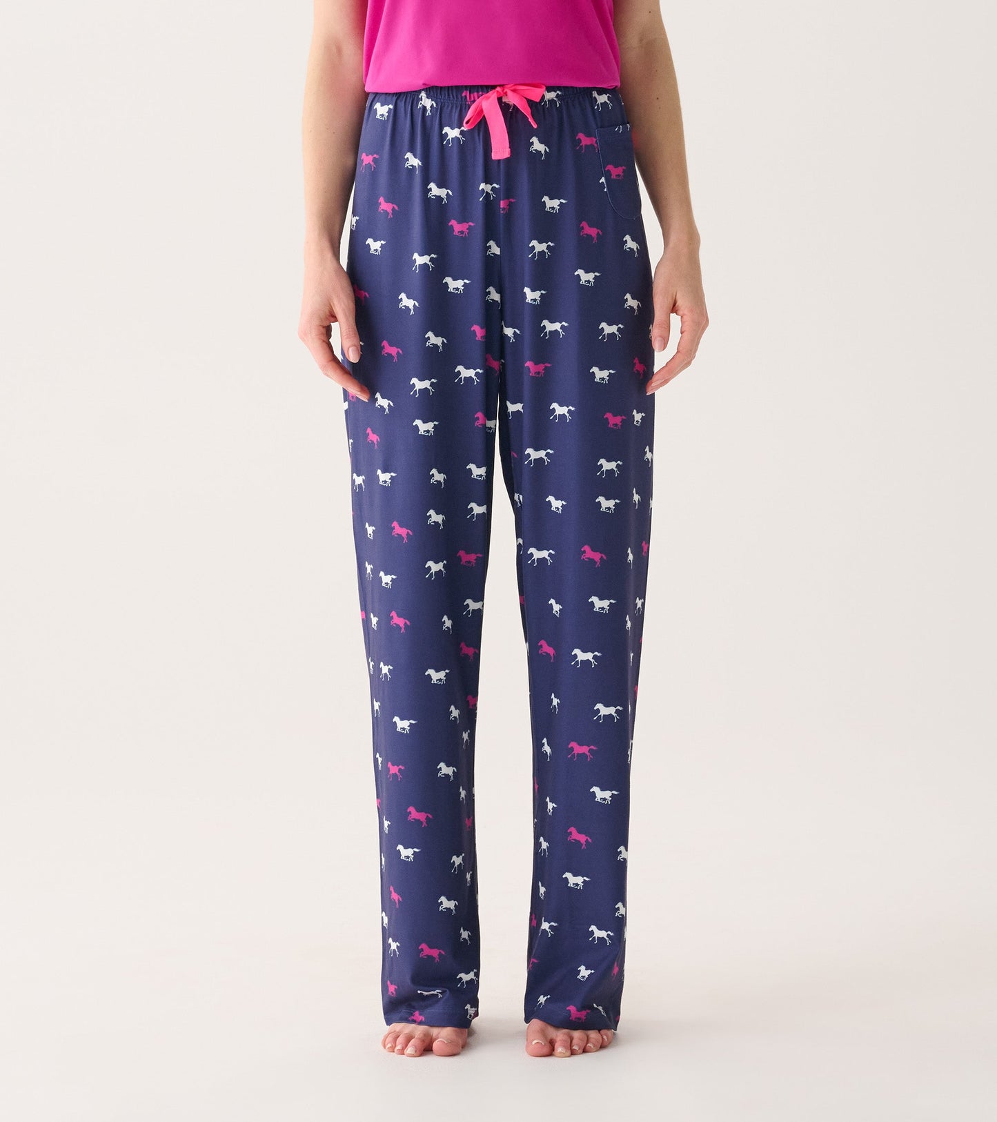 Navy pajama pants featuring a playful horse pattern in white and pink, with an elastic waistband and drawstring.
