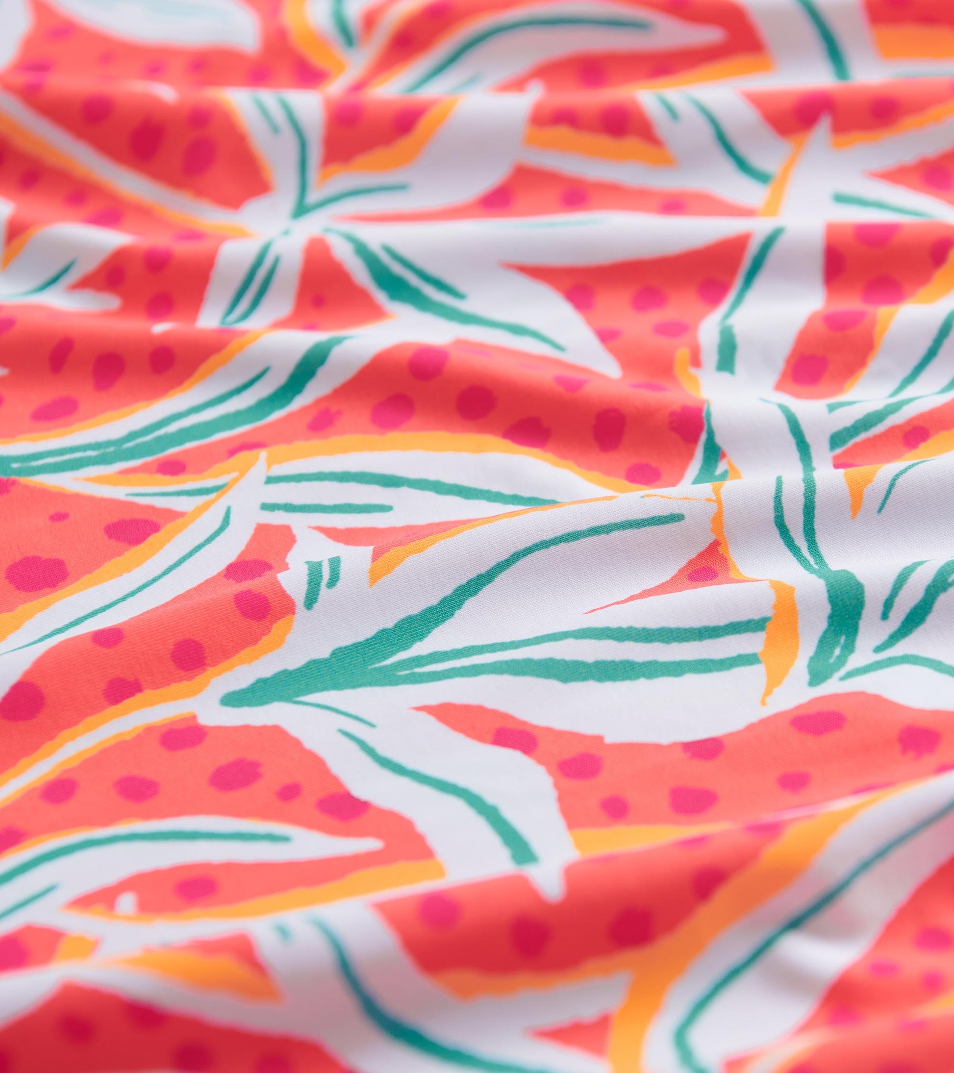 Colorful floral pattern featuring pink, orange, and green on a white background, suitable for summer wear.