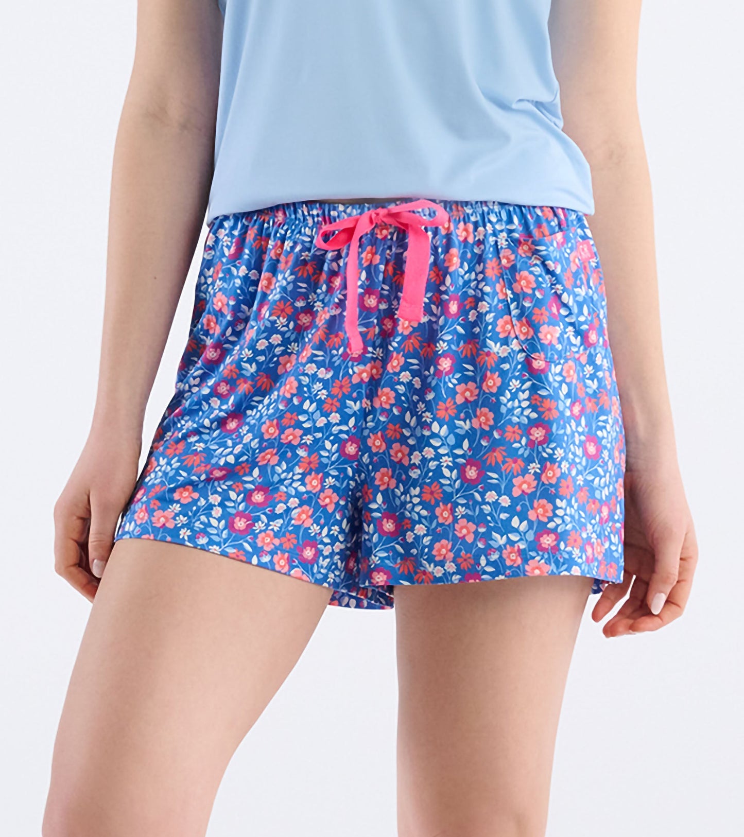 Blue pajama shorts with a colorful floral pattern and a pink drawstring, ideal for casual or sleepwear.