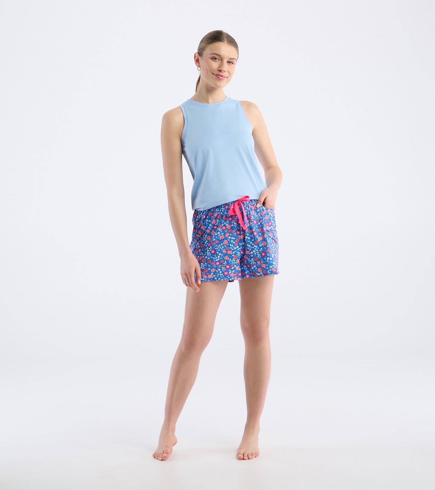 Light blue sleeveless top paired with colorful floral pajama shorts featuring a pink drawstring.
