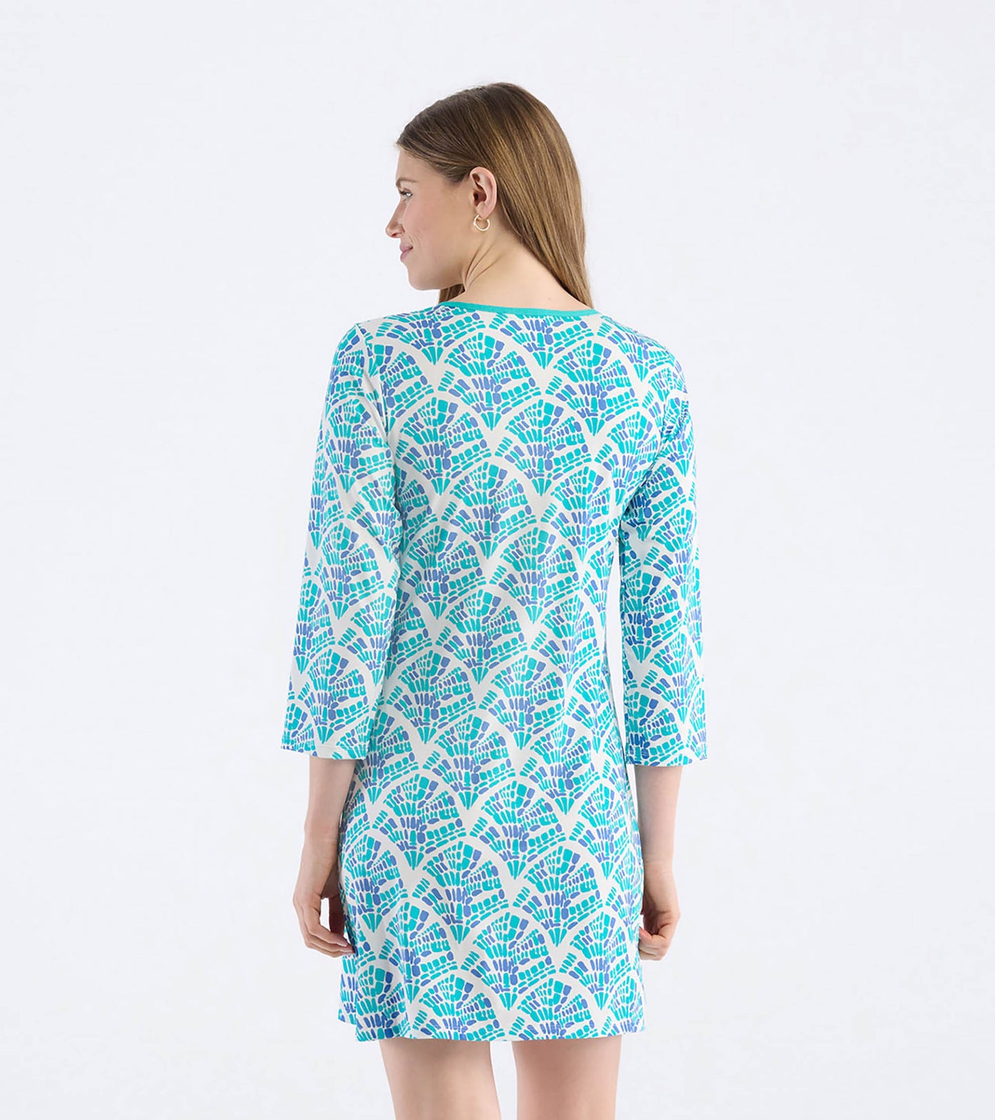 Light blue dress with a mosaic wave pattern in green and purple, featuring three-quarter sleeves and a relaxed fit.