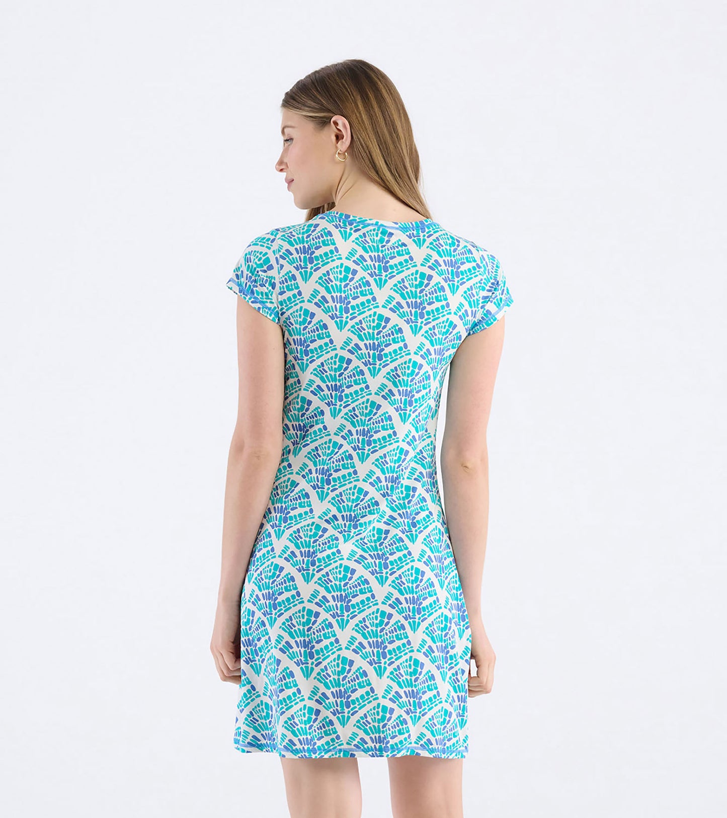 Back view of a women's t-shirt dress featuring a mosaic wave pattern in shades of blue and purple on a light background.