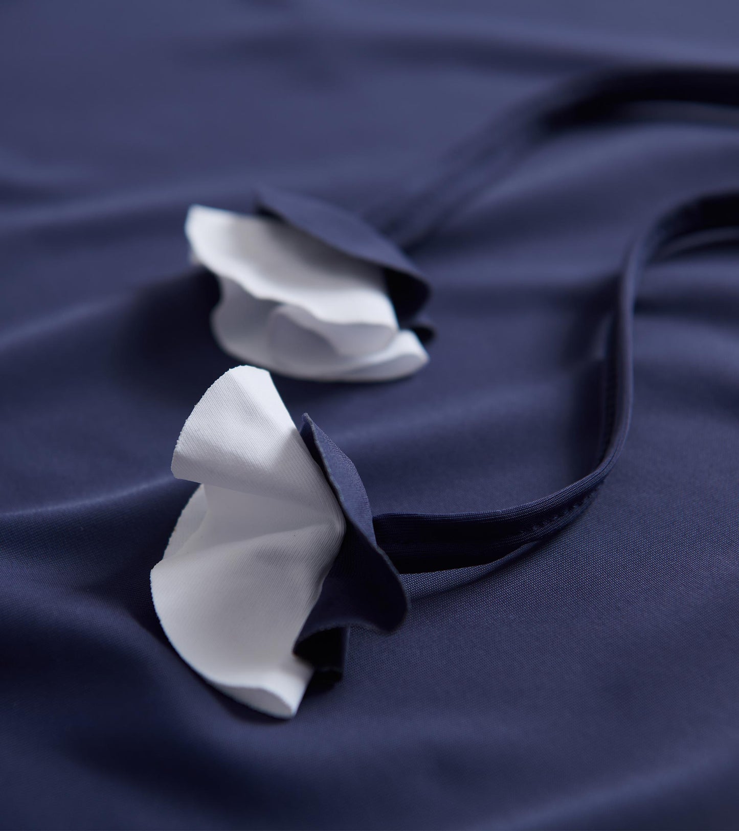 Patriot blue beach dress featuring white ruffled straps, made from soft fabric, ideal for seaside wear.