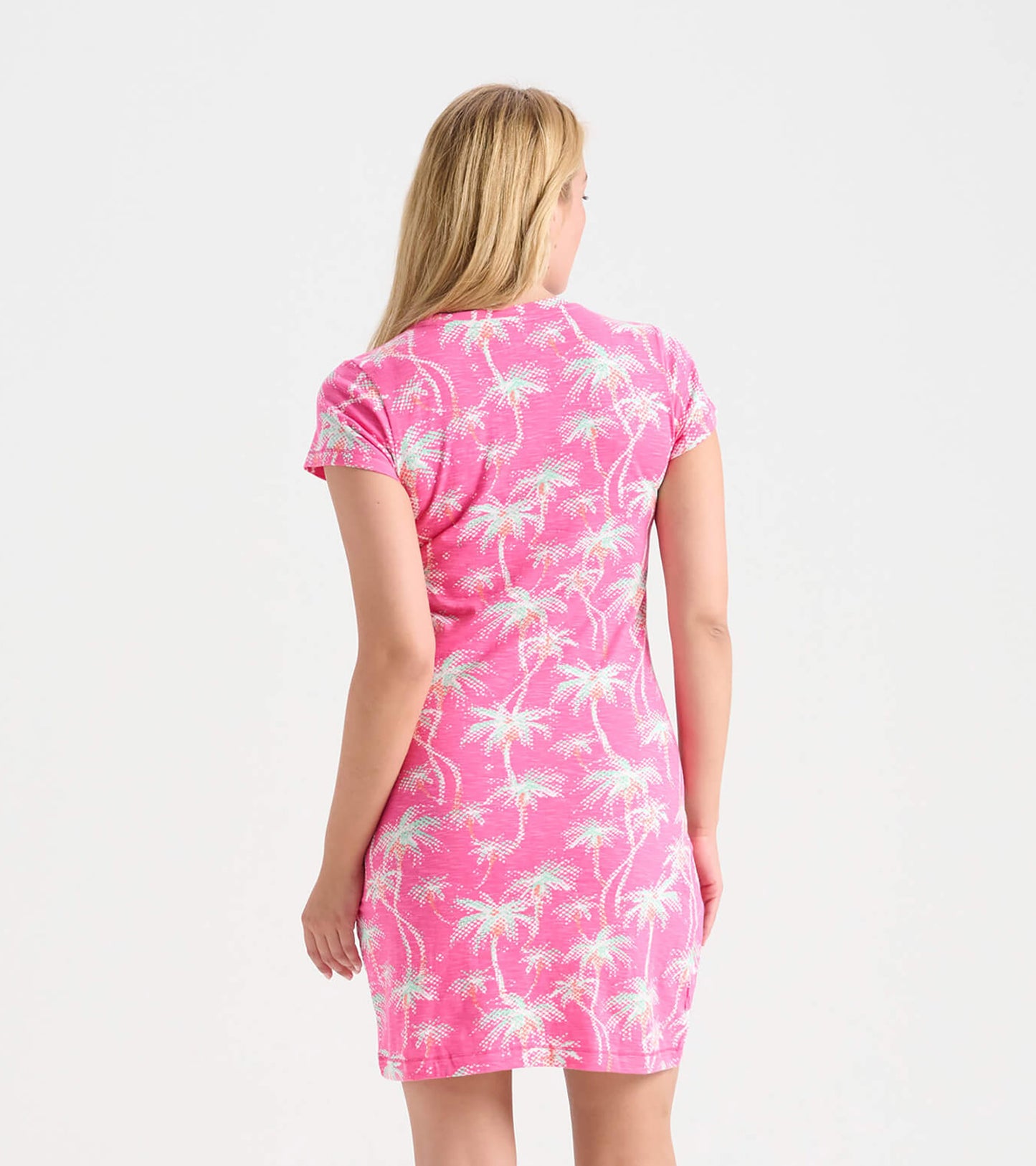 Pink crew neck t-shirt dress featuring a palm tree pattern, short sleeves, and a fitted silhouette.